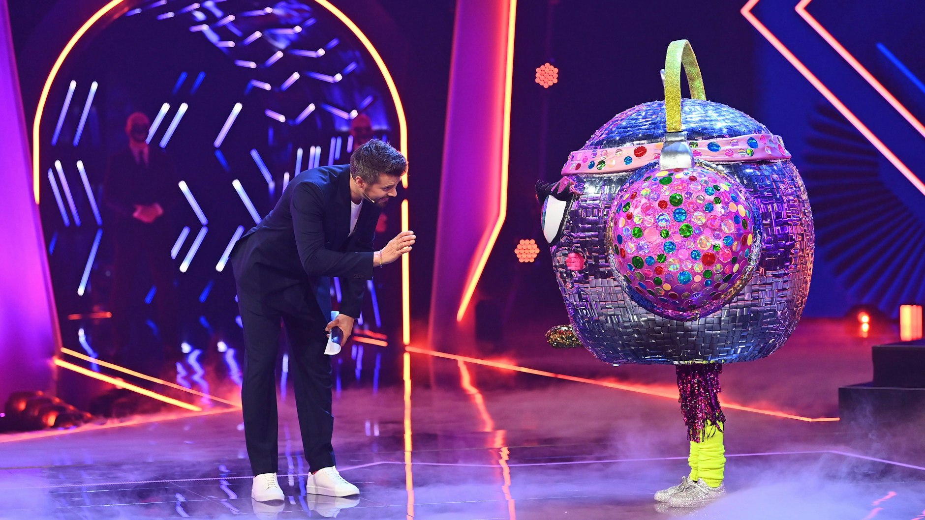 Thore Schölermann, der die erste Folge der sechsten Staffel von Masked Singer moderierte, mit der Discokugel.