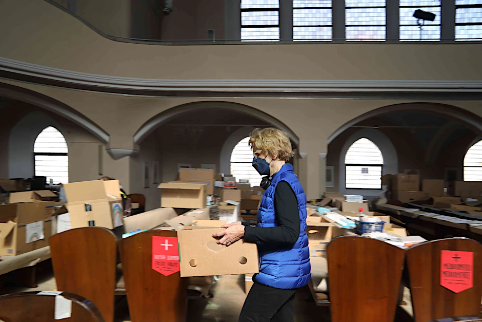 Eine Helferin packt in der Friedenauer Nathanael-Kirche Spenden für die Ukraine.