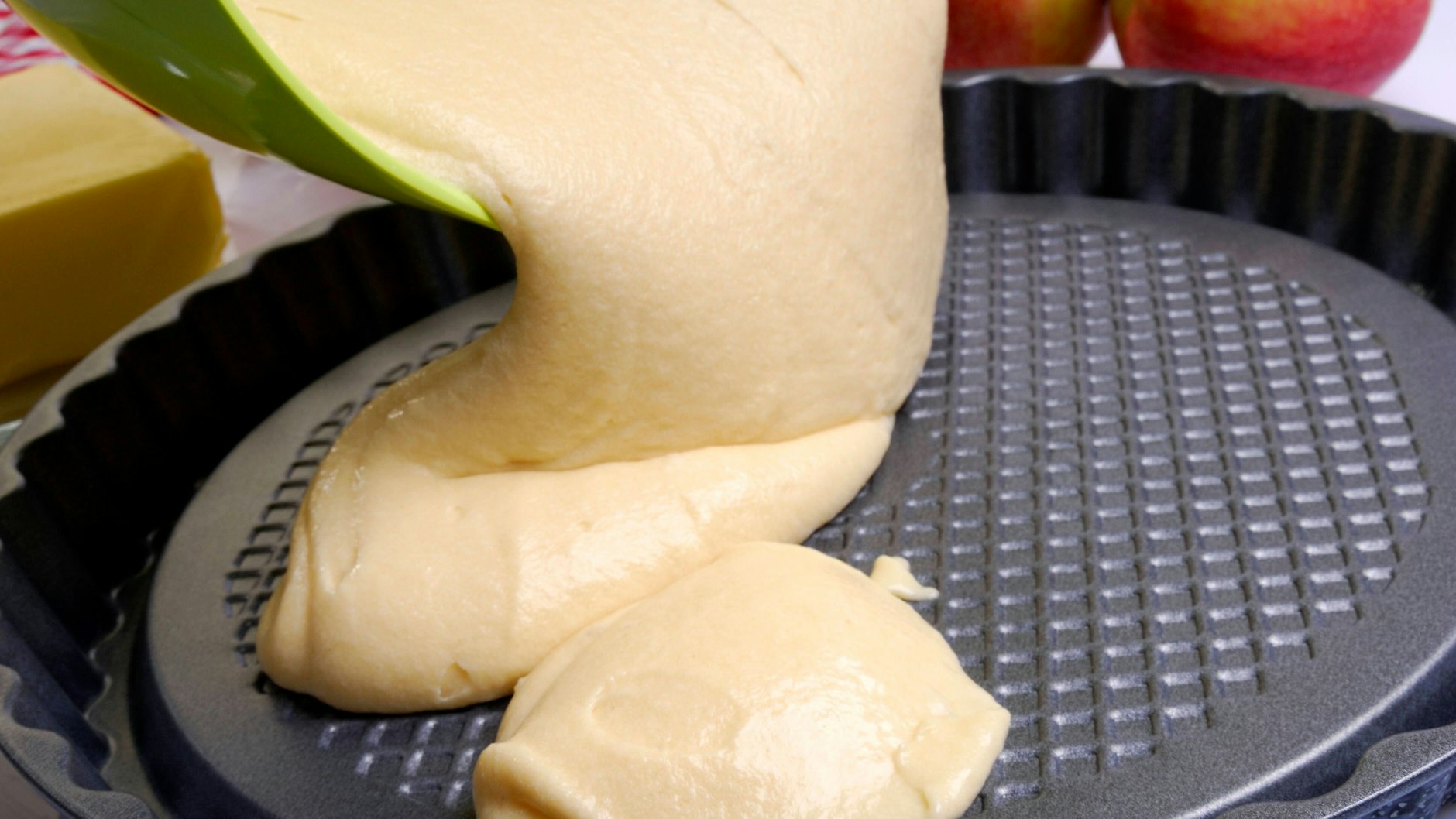 Bevor man den Teig in die Kuchenform gibt, fettet man sie am besten gut ein und streut sie mit Paniermehl aus.