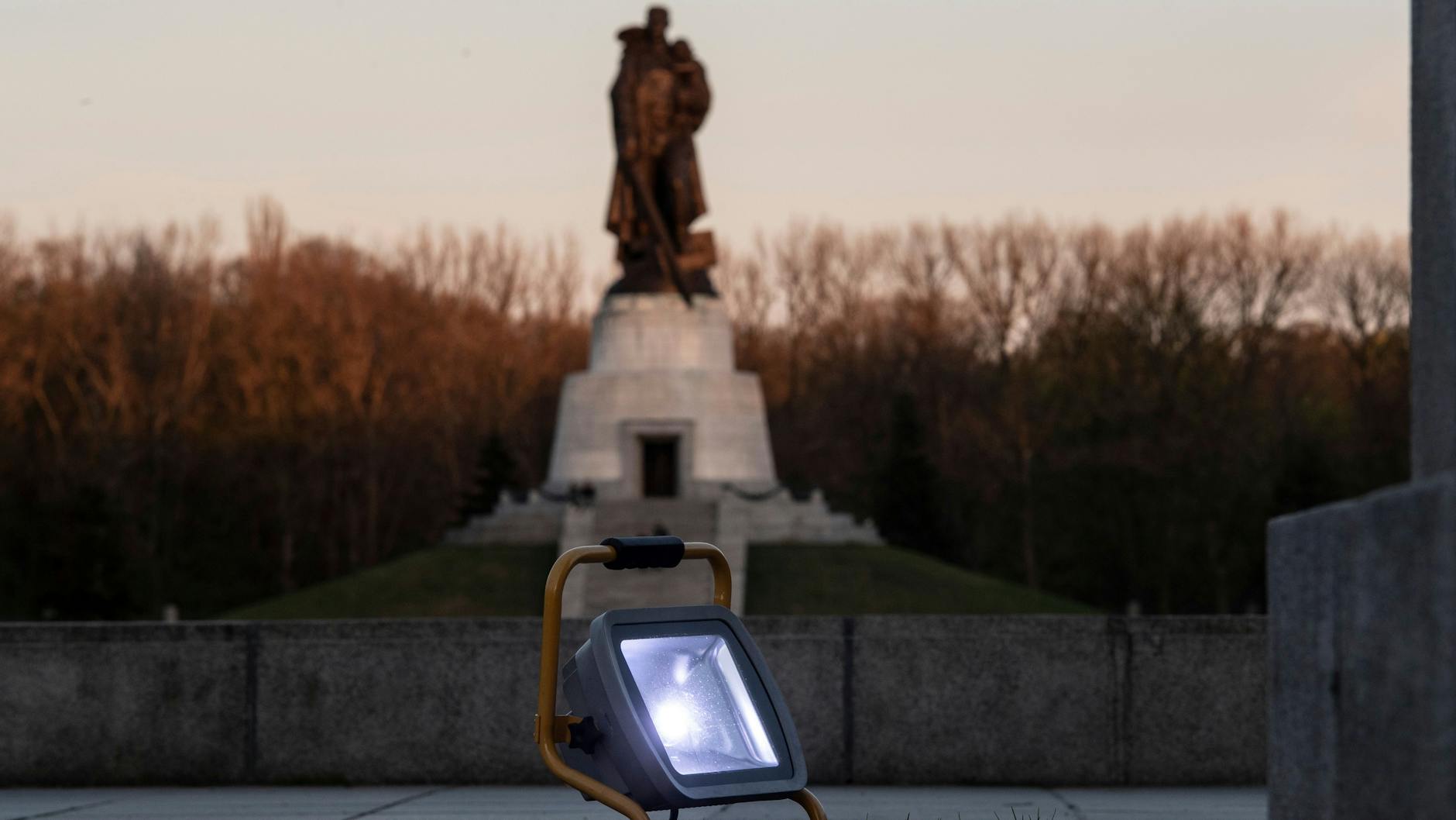 Scheinwerfer stehen auf dem Gelände des sowjetischen Ehrenmals im Treptower Park. Seit dem russischen Angriff auf die Ukraine haben Unbekannte mehrfach Parolen auf das Denkmal geschmiert.