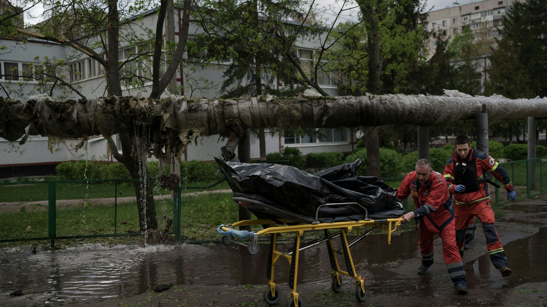 Rettungskräfte bergen die Leiche eines Mannes, der während eines russischen Bombardements in Charkiw getötet wurde.