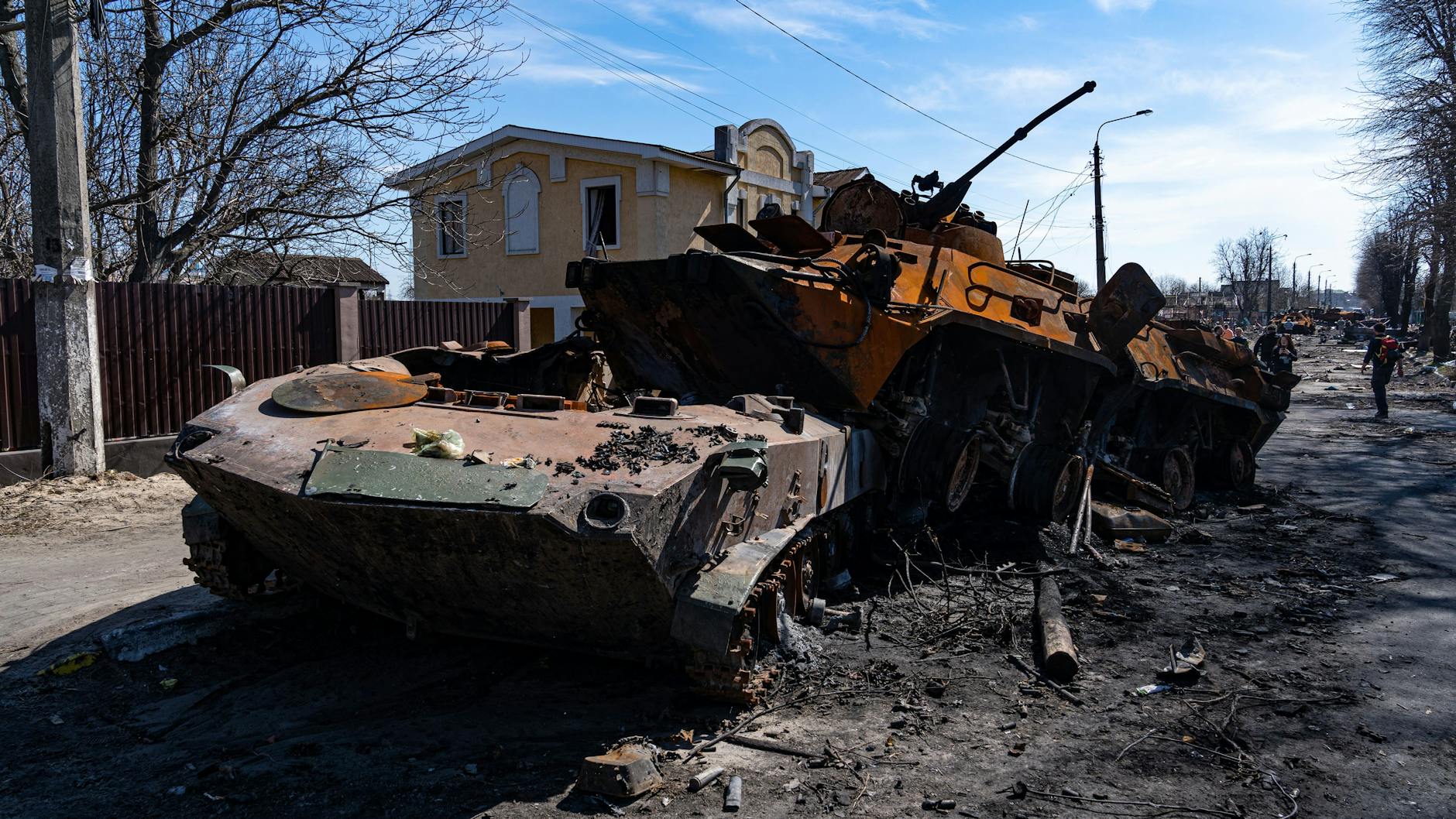 Ukraine: Zerstörte Militärfahrzeuge stehen auf einer Straße in Butscha.