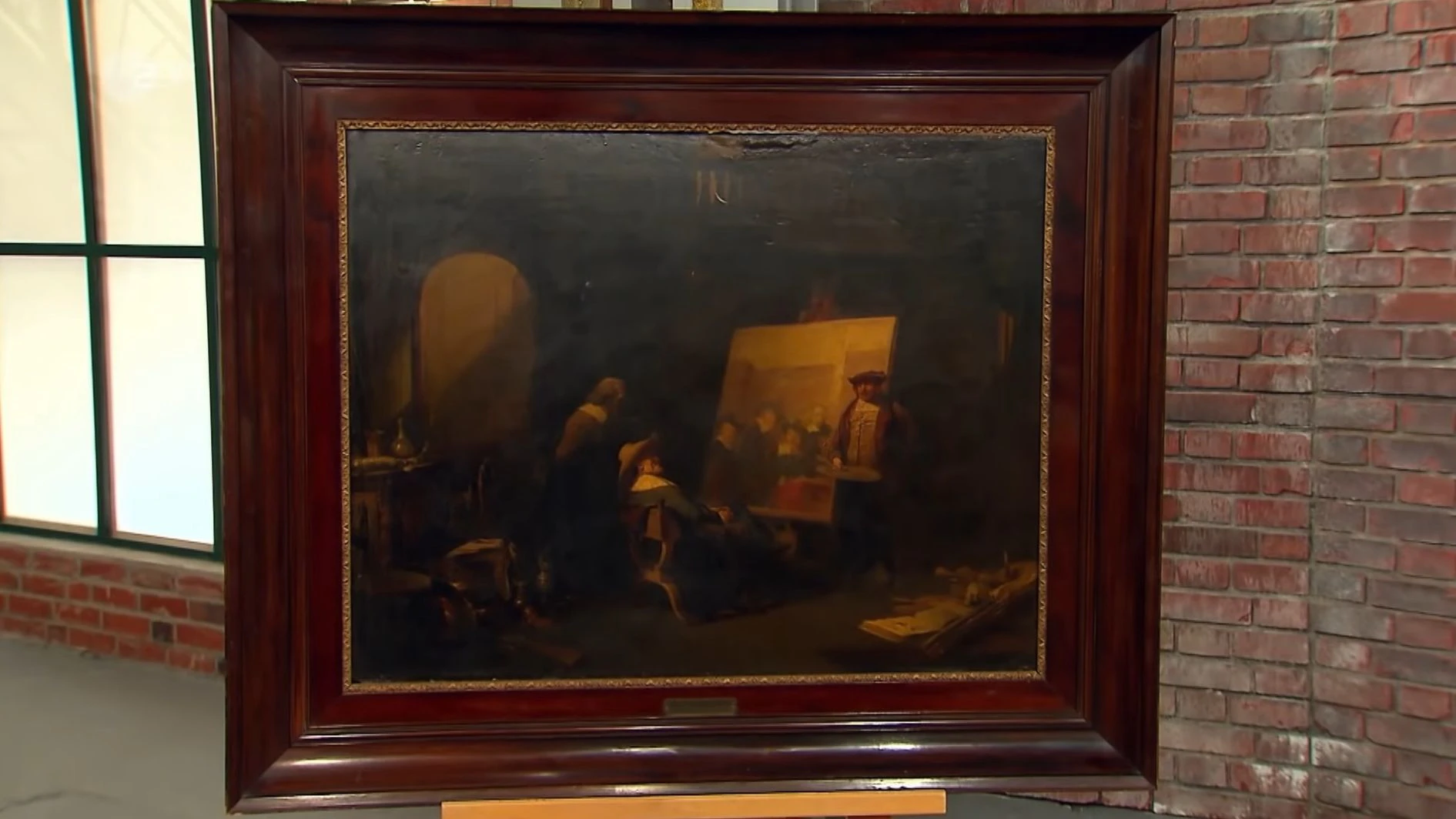 Das Bild bei „Bares für Rares“ zeigt eine Szene, in der Rembrandt in seinem Atelier neben seinem unvollendeten Bild der Tuchmacherzunft steht.
