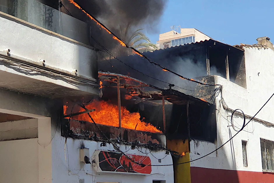 Flammen schlagen aus dem Restaurant Why not Mallorca?. Die Polizei hat auf Mallorca 13 deutsche Urlauber festgenommen, weil sie den Brand ausgelöst haben sollen.