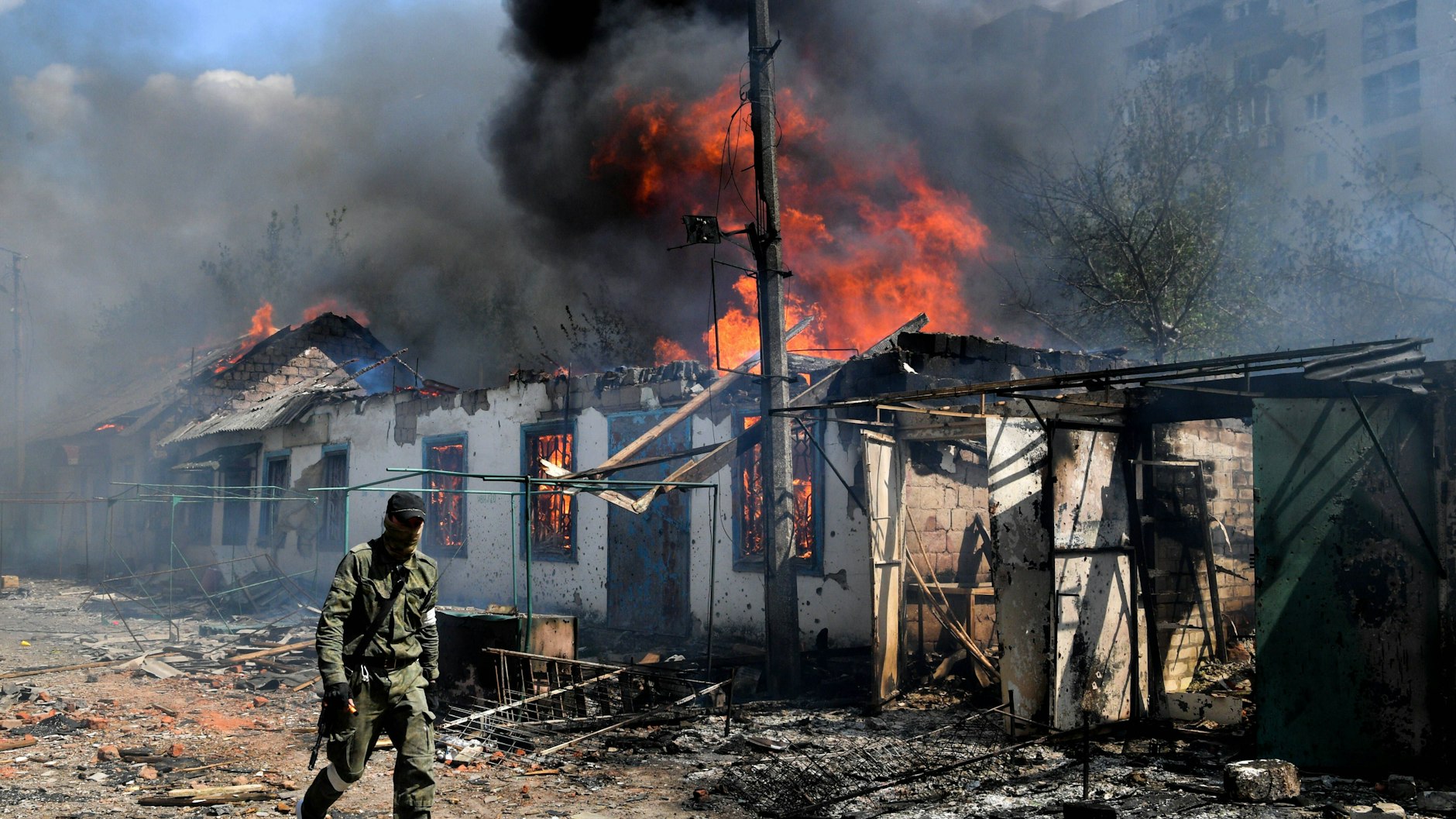 In einem Dorf im Verwaltungsgebiet Luhansk brennt ein Gebäude (Archivbild). Weite Teile des Gebiets im Donbass seien mittlerweile von den Russen erobert.