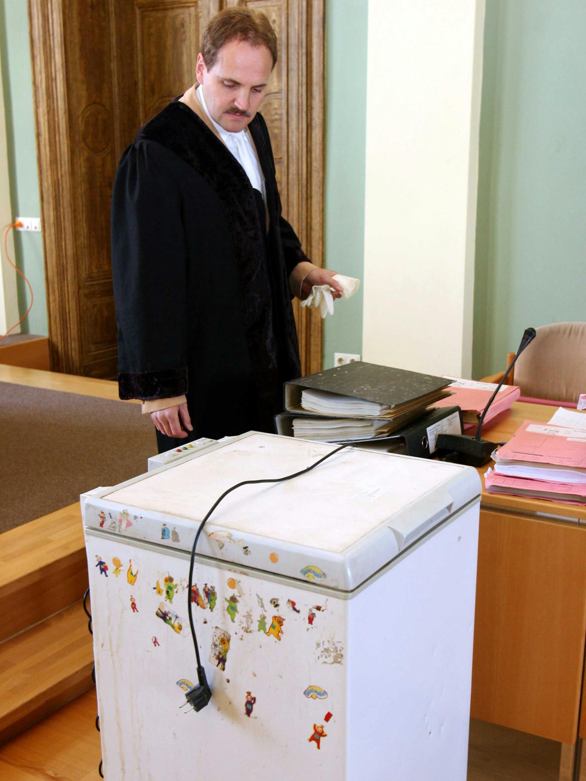 Der Staatsanwalt Tobias Pinder präsentiert im Prozess die Kühltruhe, in der die Leiche von Dennis lag.