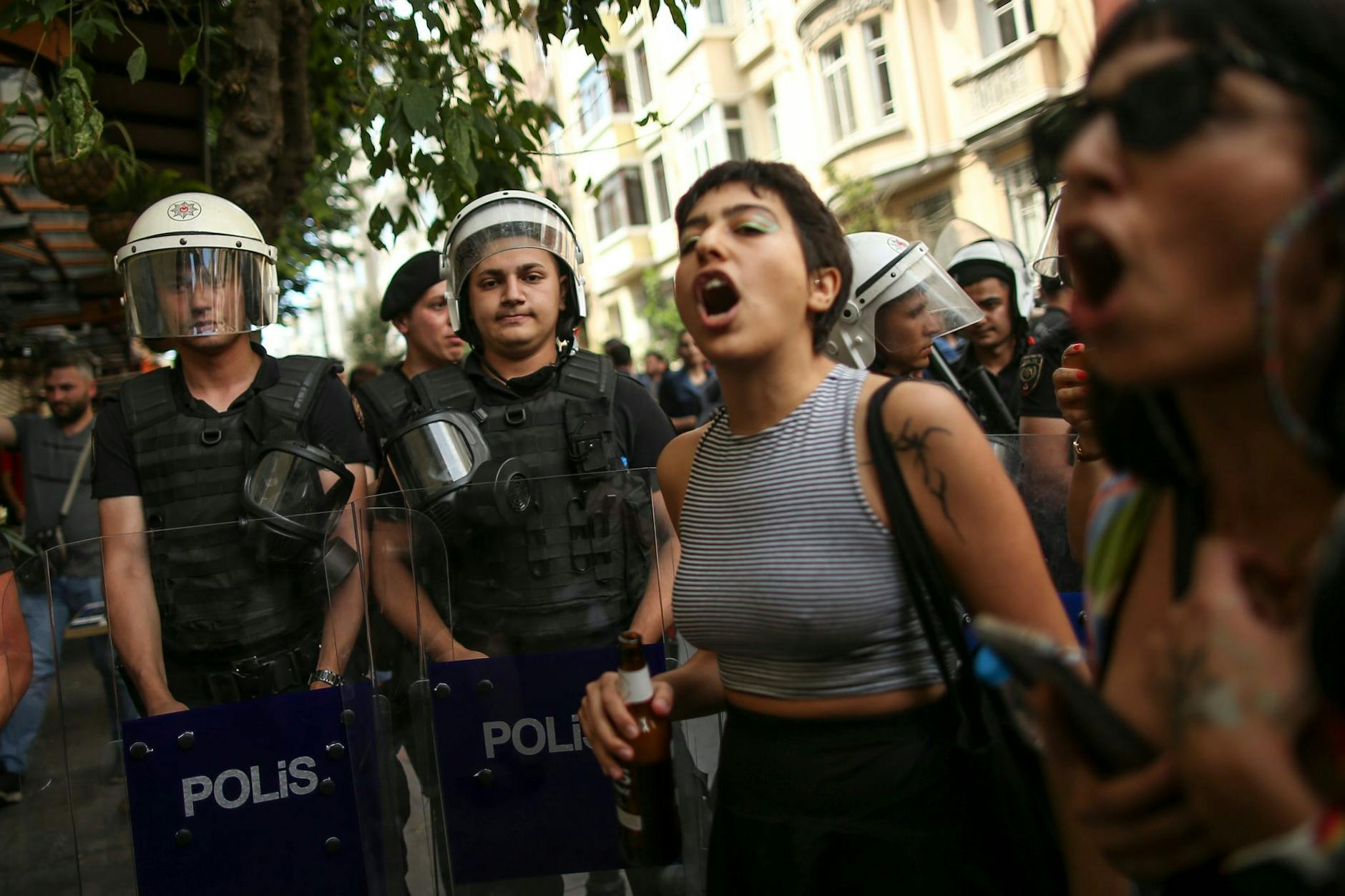 dpatopbilder - Teilnehmende der Pride-Parade in Istanbul stehen neben Polizisten und rufen Slogans.