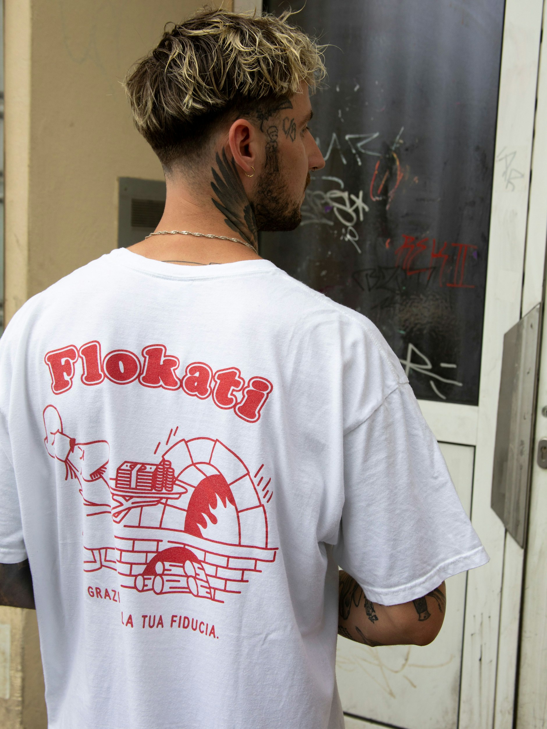 Die Halskette ist ein Geschenk seiner Ex-Freundin, das T-Shirt mit Fantasie-Pizza-Print vom Freund.