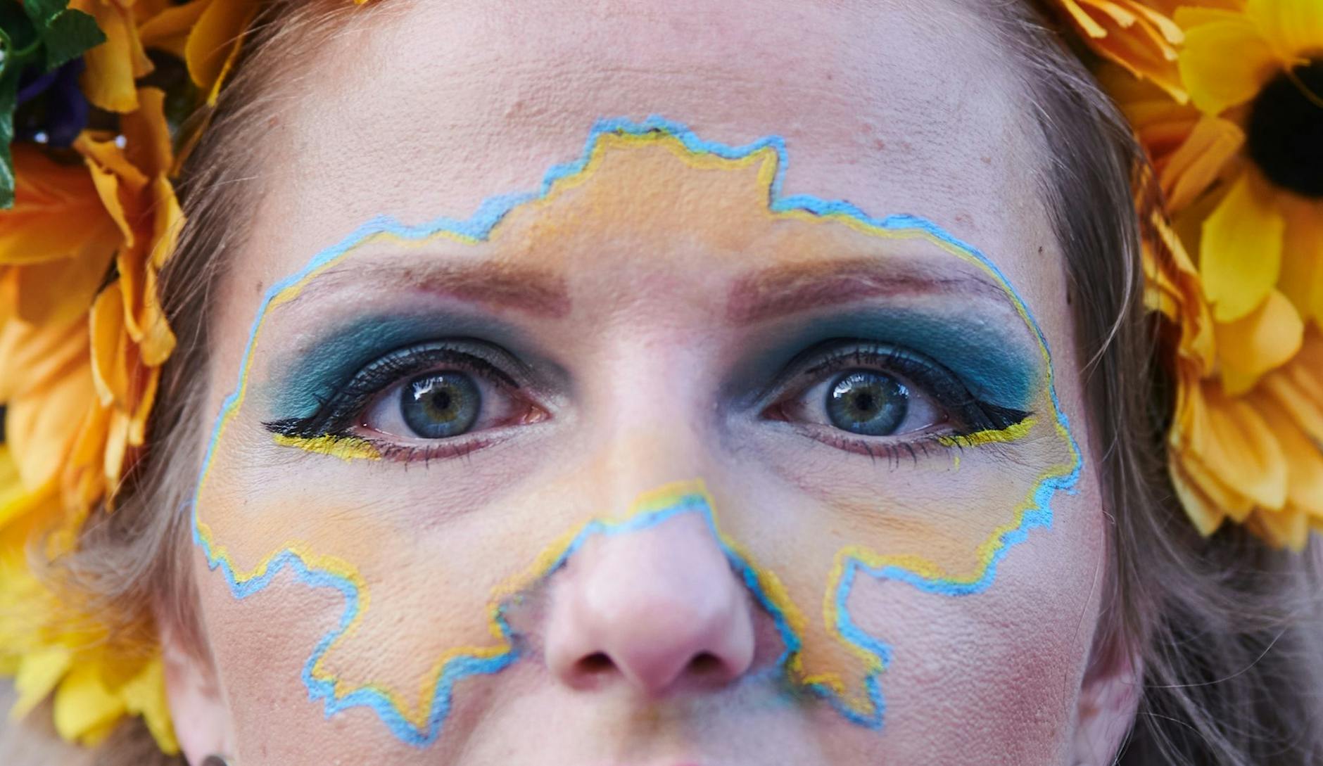 Eine Demonstrantin hat sich zum Protestmarsch des Vereins «Vitsche» in Berlin zum Unabhängigkeitstag der Ukraine den Umriss des Landes ins Gesicht gemalt.