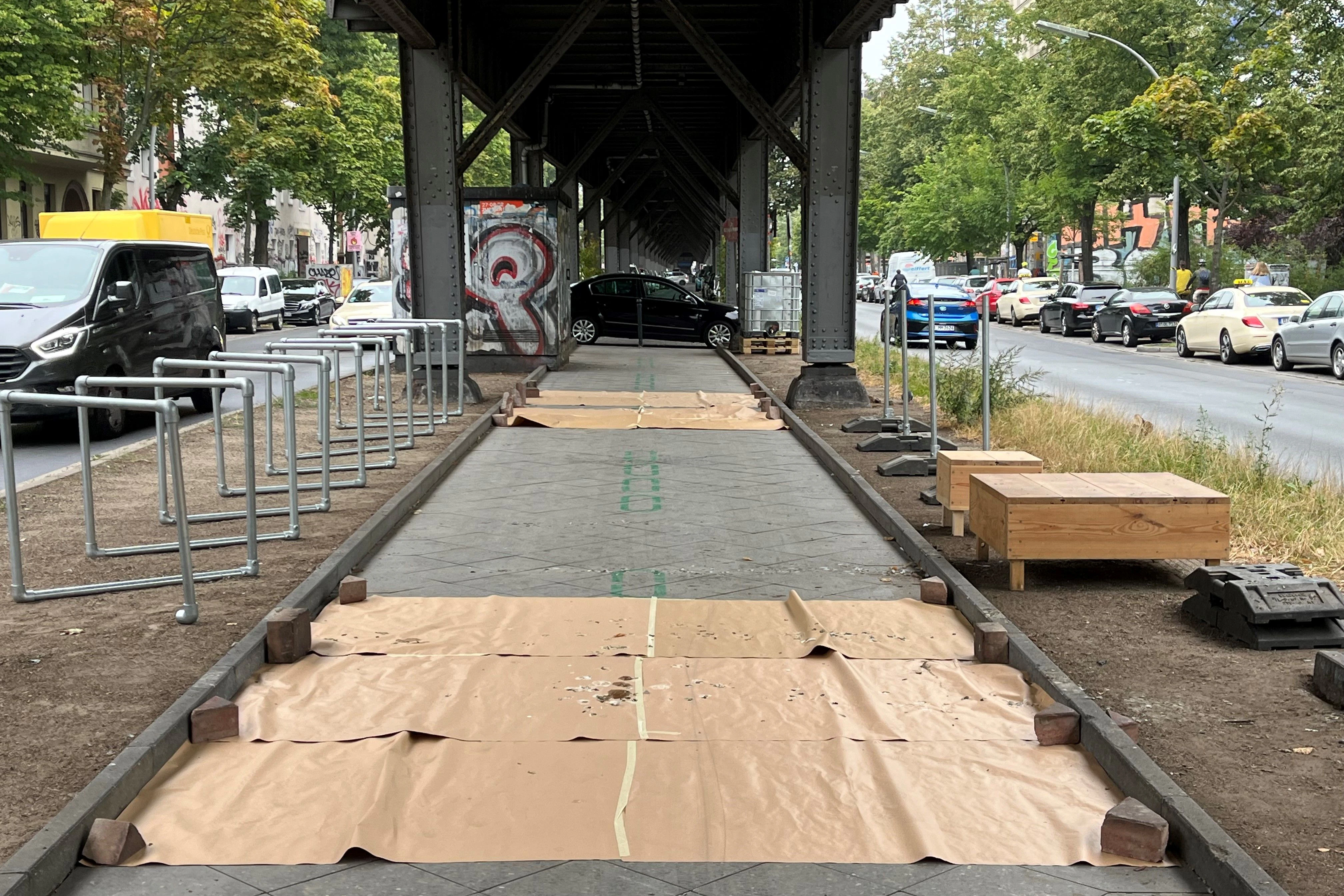 Nachts schützen Papierbahnen das Testfeld der Radbahn vor Taubenkot. Trotz Bewachung hat ein Autofahrer sein Fahrzeug in den abgesperrten Bereich gestellt.