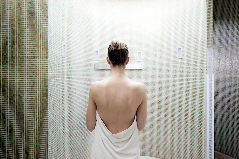 Eine Frau im Dampfbad einer Wellnessanlage