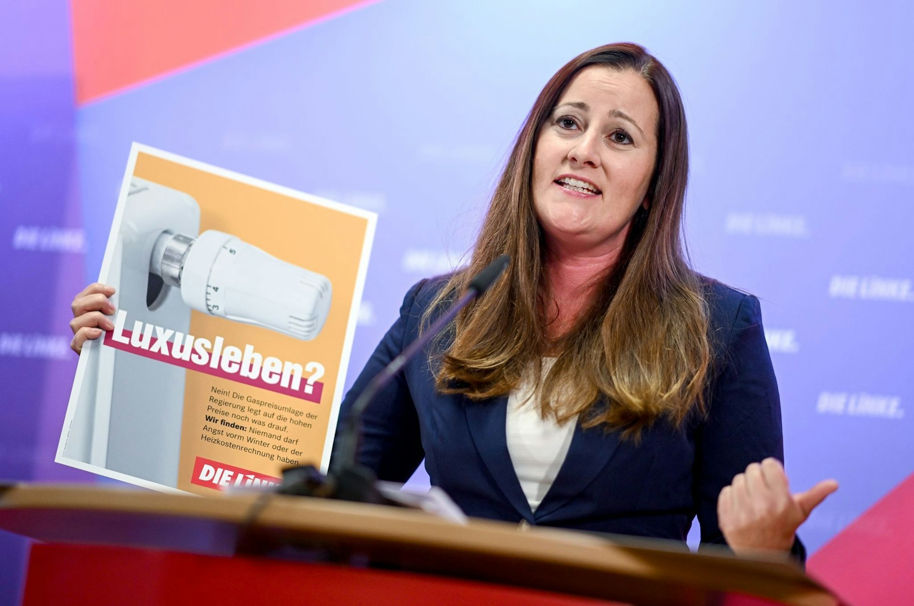 Linken-Chefin Janine Wissler präsentiert ein Plakat für die Kampagne «Menschen entlasten. Preise deckeln. Übergewinne besteuern».