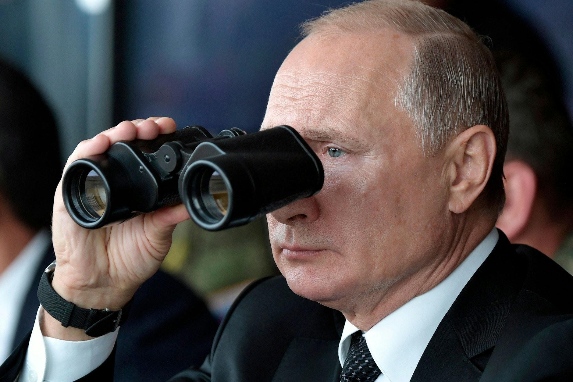 Durch ein Fernglas beobachtet Wladimir Putin, Präsident von Russland, eine Militärübung.