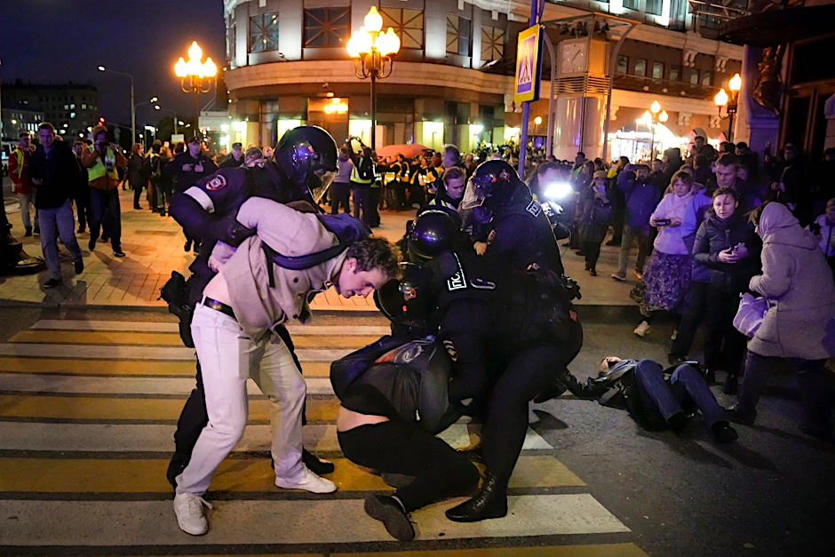 Russische Polizisten halten Demonstranten in Moskau fest.