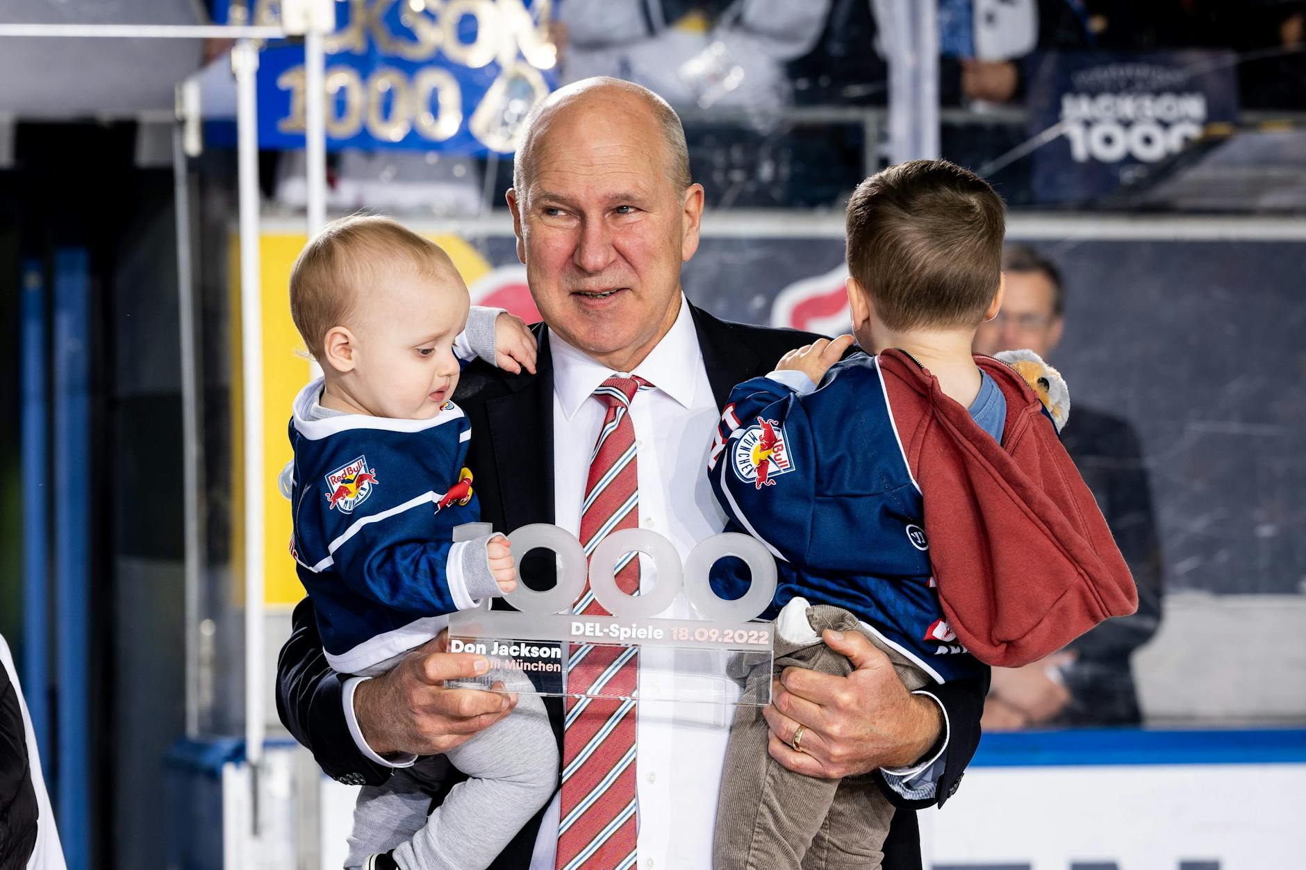 Don Jackson beim Jubiläum 1000 DEL-Spiele mit Pokal und seinen beiden Enkeln.