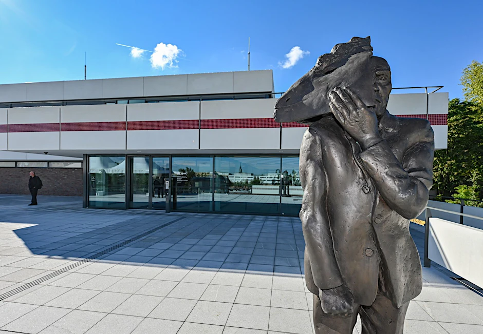 Mattheuers Bronzeskulptur „Maskenmann / Gesicht zeigen“ steht vor dem Kunsthaus Minsk in Potsdam.