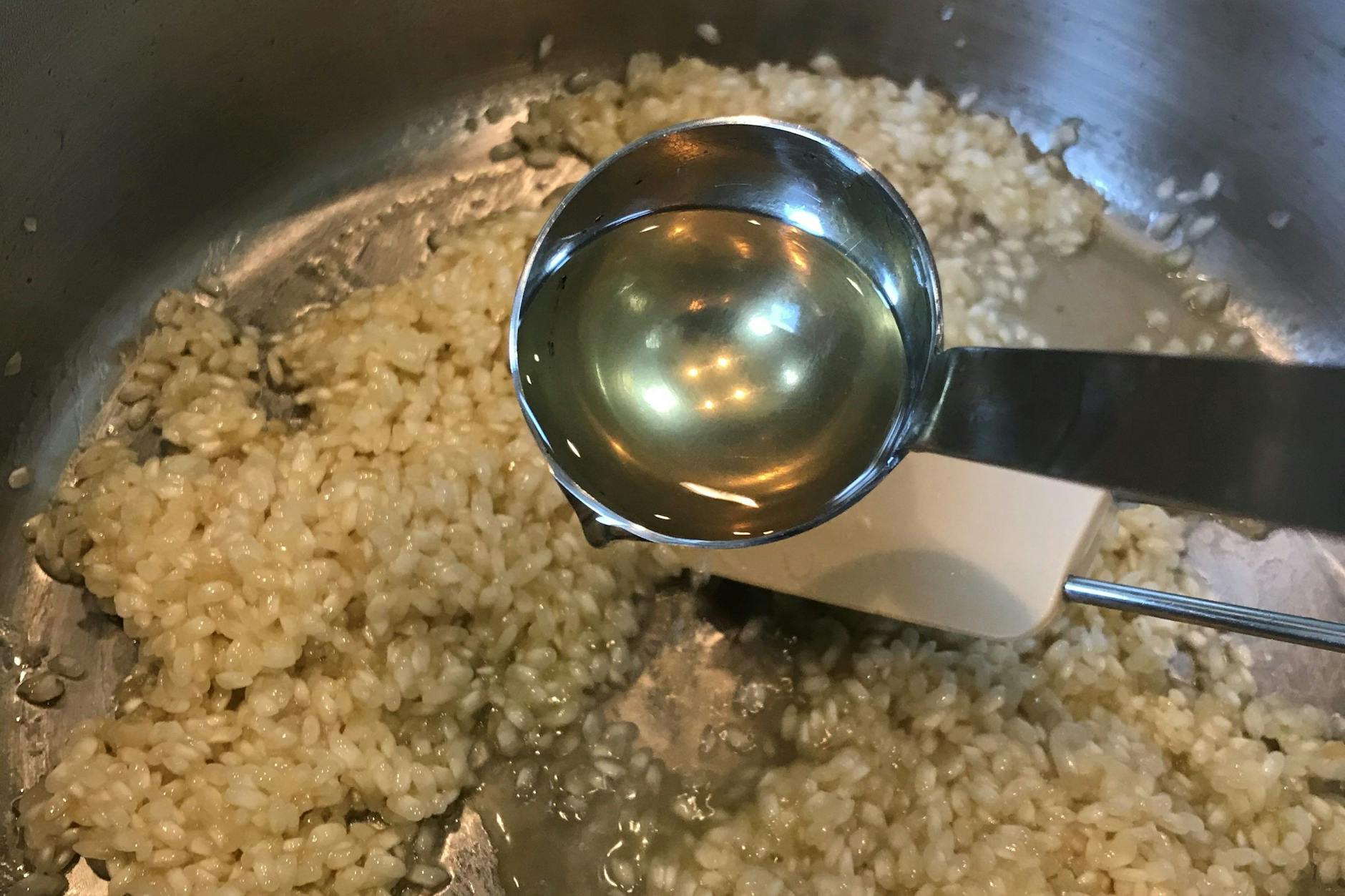Immer schön Brühe angießen, bis das Risotto perfekt schlotzig ist.