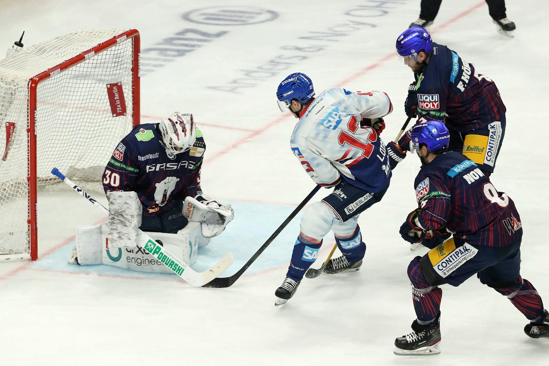 Torwart Juho Markkanen von den Eisbären Berlin im Duell mit Stefan Loibl von Adler Mannheim.