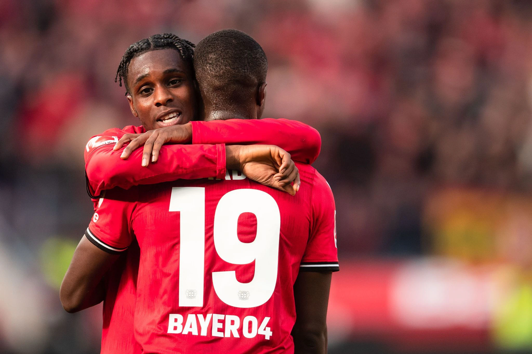 Die Leverkusener Jeremie Frimpong (l) und Moussa Diaby bejubeln den Sieg gegen den FC Schalke 04.   - Nutzung nur nach schriftlicher Vereinbarung mit der dpa