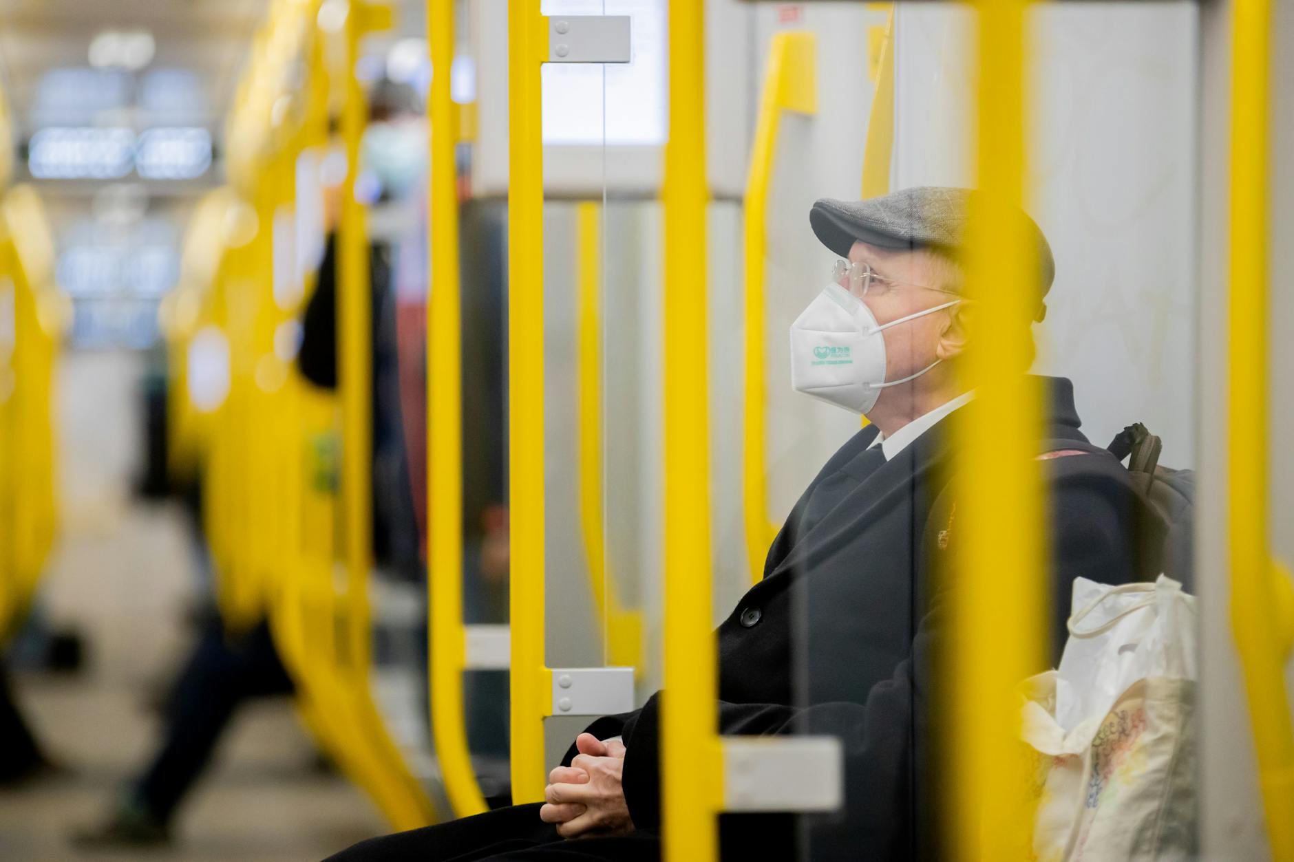 Ein Mann sitzt mit FFP2-Maske in einer U-Bahn. In Berlin ist das im ÖPNV vorgeschrieben. 