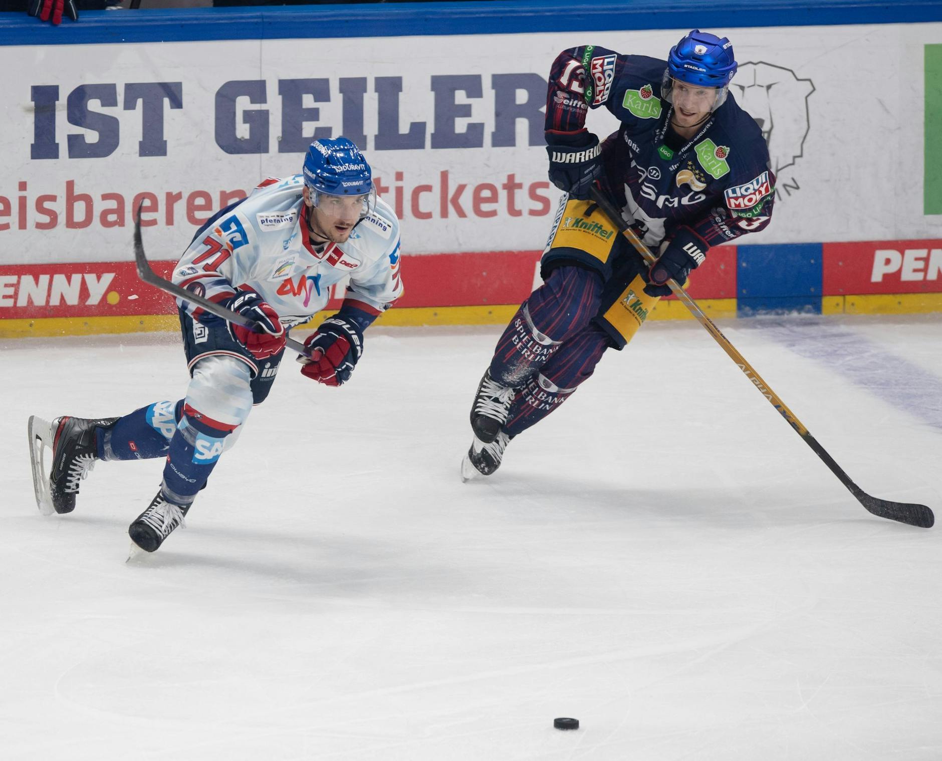 ARCHIV - Mannheims Borna Rendulic (l) und Berlins Peter Regin jagen den Puck nach.