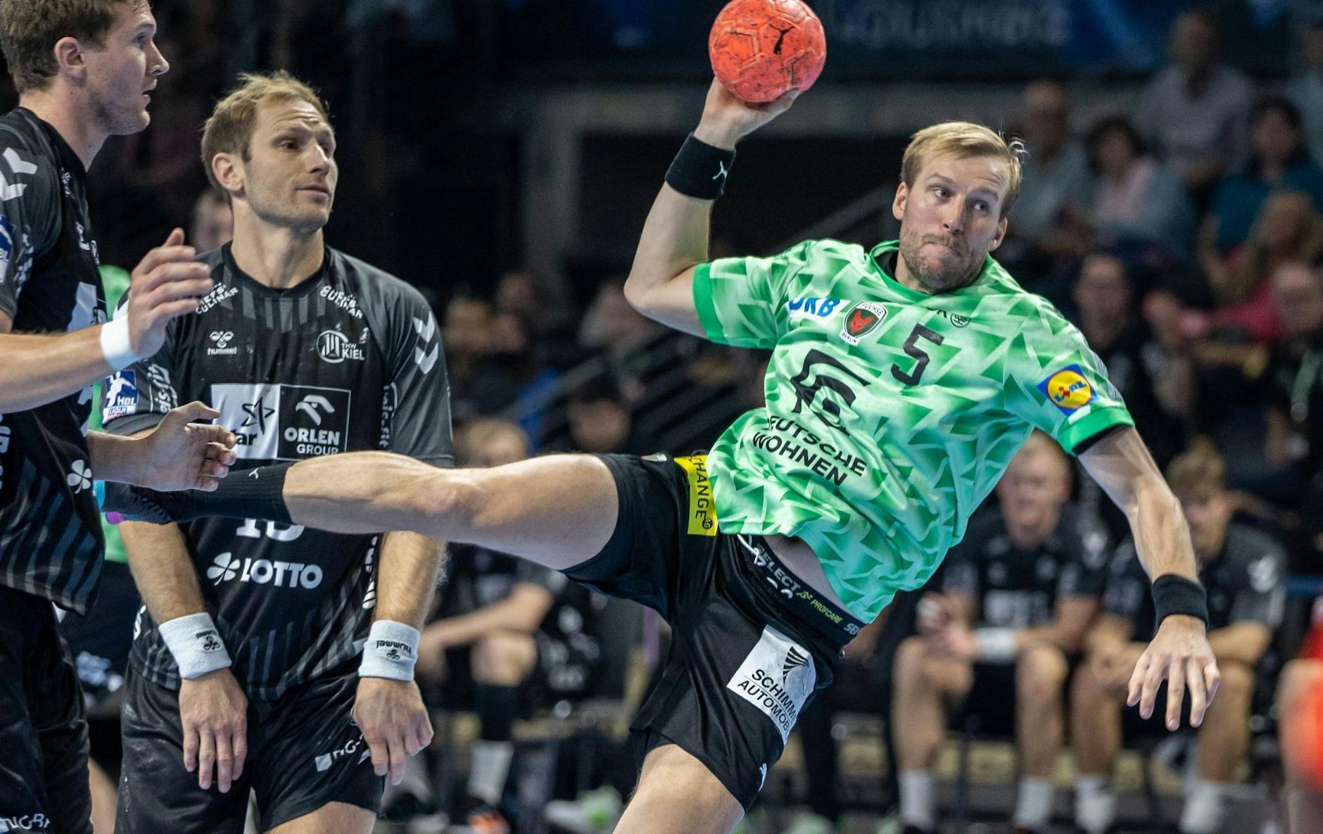 ARCHIV - Berlins Max Darj (r) wirft den Ball auf das Tor neben Steffen Weinhold von THW Kiel.