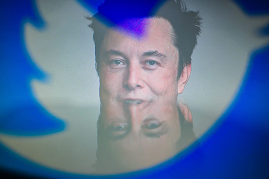 Elon Musk, CEO von Tesla und SpaceX, hinter den Silhouetten des Twitter-Logos.