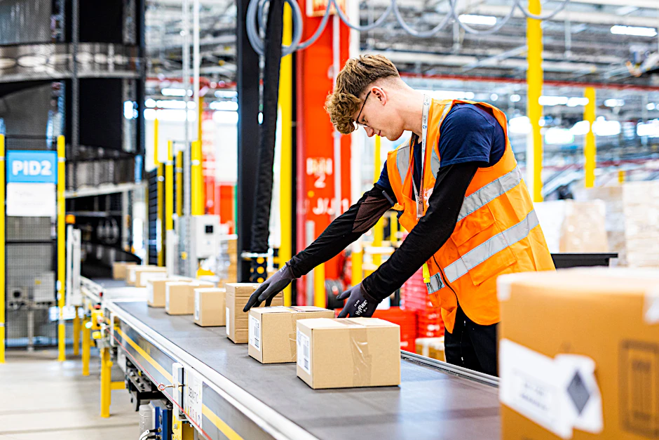 Ein Mitarbeiter legt im neuen Logistikzentrum des Onlineversandhändlers Amazon. Der Standort in Brieselang nahe Berlin soll geschlossen werden. Verdi betrachtet die Entscheidung mit Sorge.