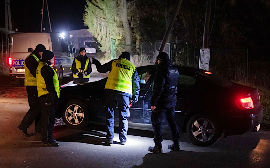 Polizisten versammeln sich vor einem Getreidelager in Przewodów im Südosten Polens. Nach einer Explosion mit zwei Toten hat Polen einen Teil seiner Streitkräfte in erhöhte Bereitschaft versetzt.