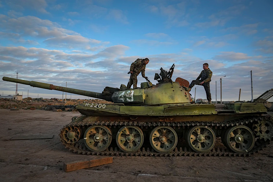 Ukrainische Soldaten suchen in einem beschädigten russischen Panzer nach Feinden.&nbsp;