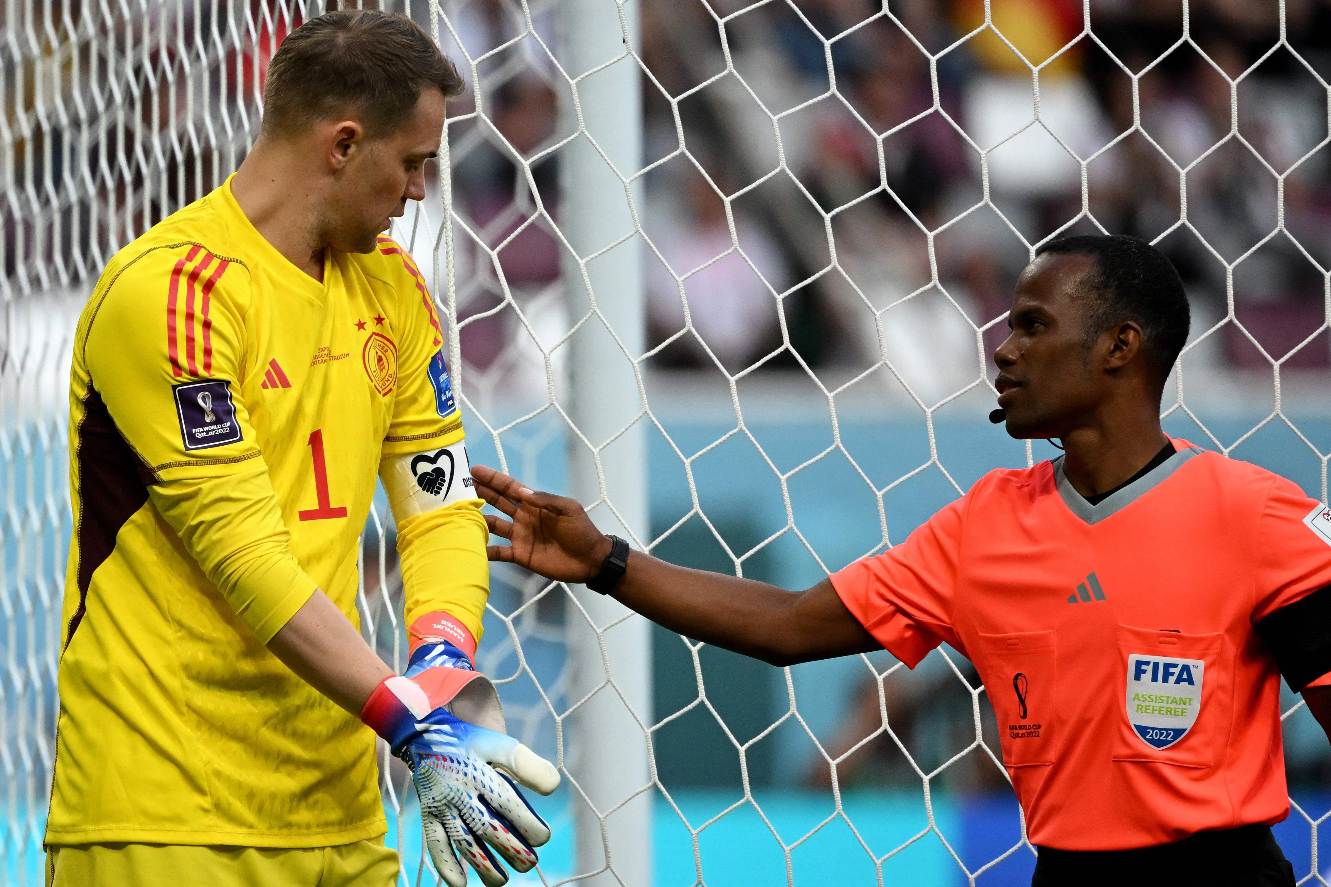 Ein Schiedsrichterassistent prüft die Kapitänsbinde von Manuel Neuer, der im Anschluss die Niederlage gegen Japan nicht verhindern kann.