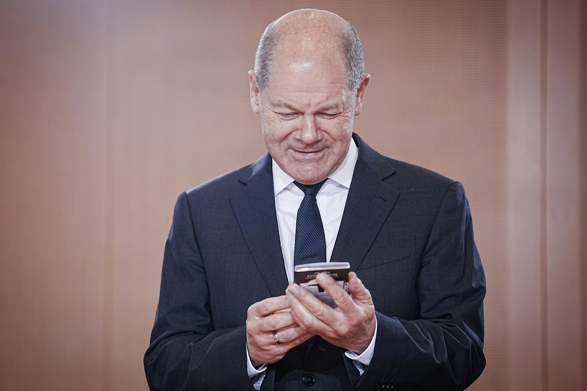 Bundeskanzler Olaf Scholz (SPD) schaut sich während der Sitzung des Bundeskabinetts, anlässlich des ersten Geburtstags der Ampelkoalition, eine Tafel Schokolade mit der Geschmacksrichtung Zartbitter im Bundeskanzleramt an.