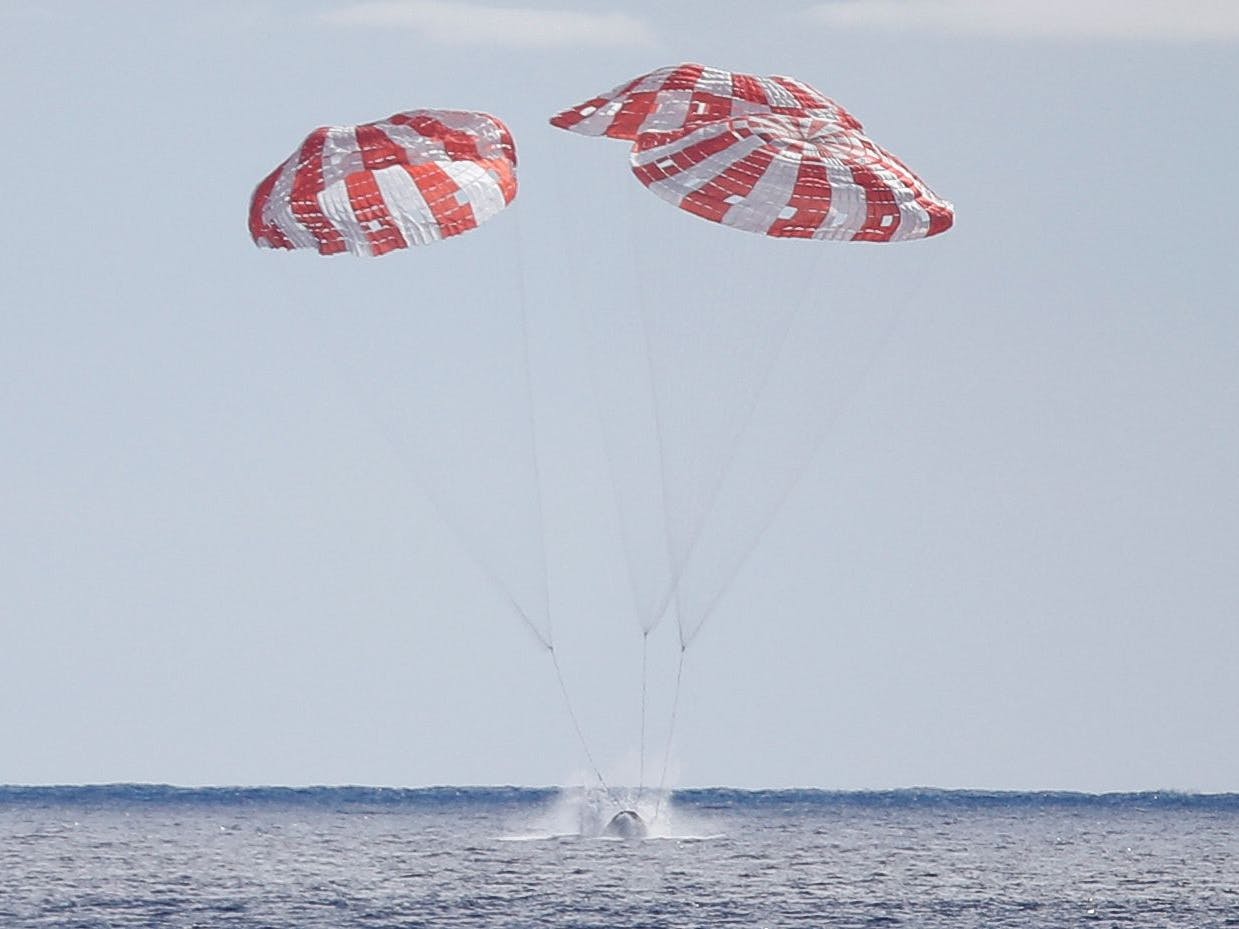 Platsch: Die Orion-Kapsel landet im Pazifik, von drei Fallschirmen abgebremst.