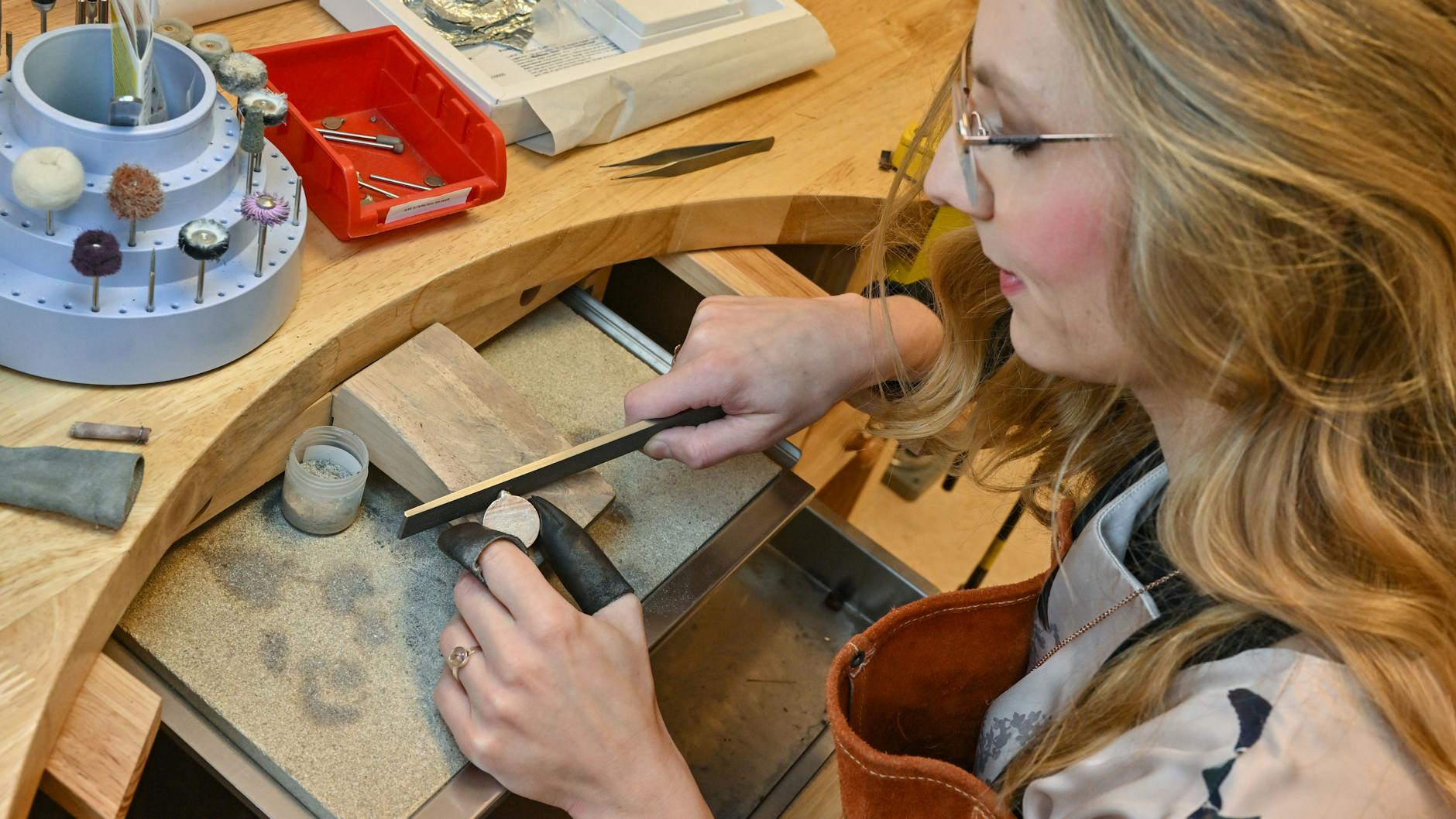 Josephin Hammer, Schmuckdesignerin und Inhaberin der milk-design Manufaktur GmbH, arbeitet an einem Goldschmiedearbeitsplatz in ihrer Werkstatt.