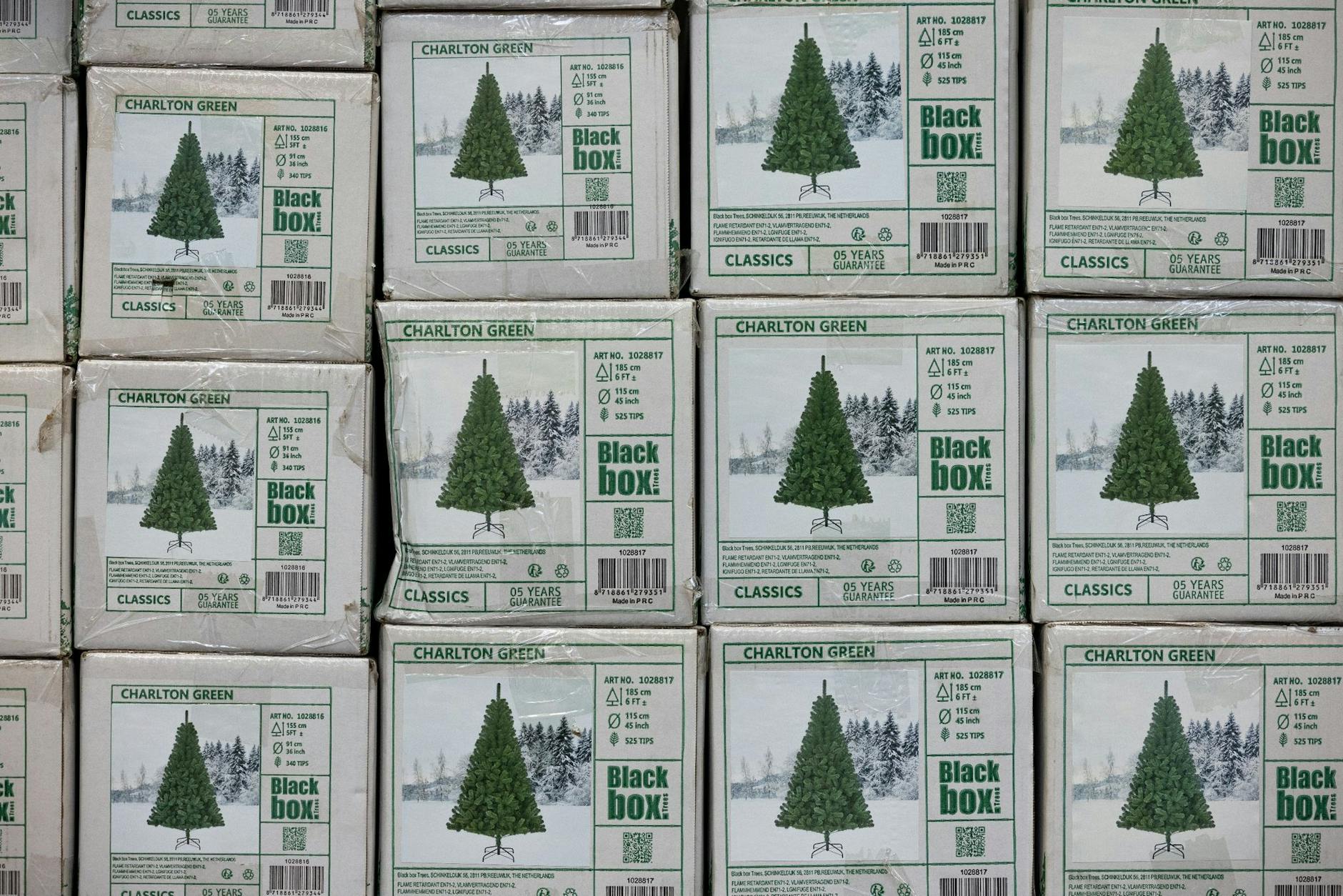 PRODUKTION - Verpackte Weihnachtsbäume aus Kunststoff (PVC) in einem Baumarkt.