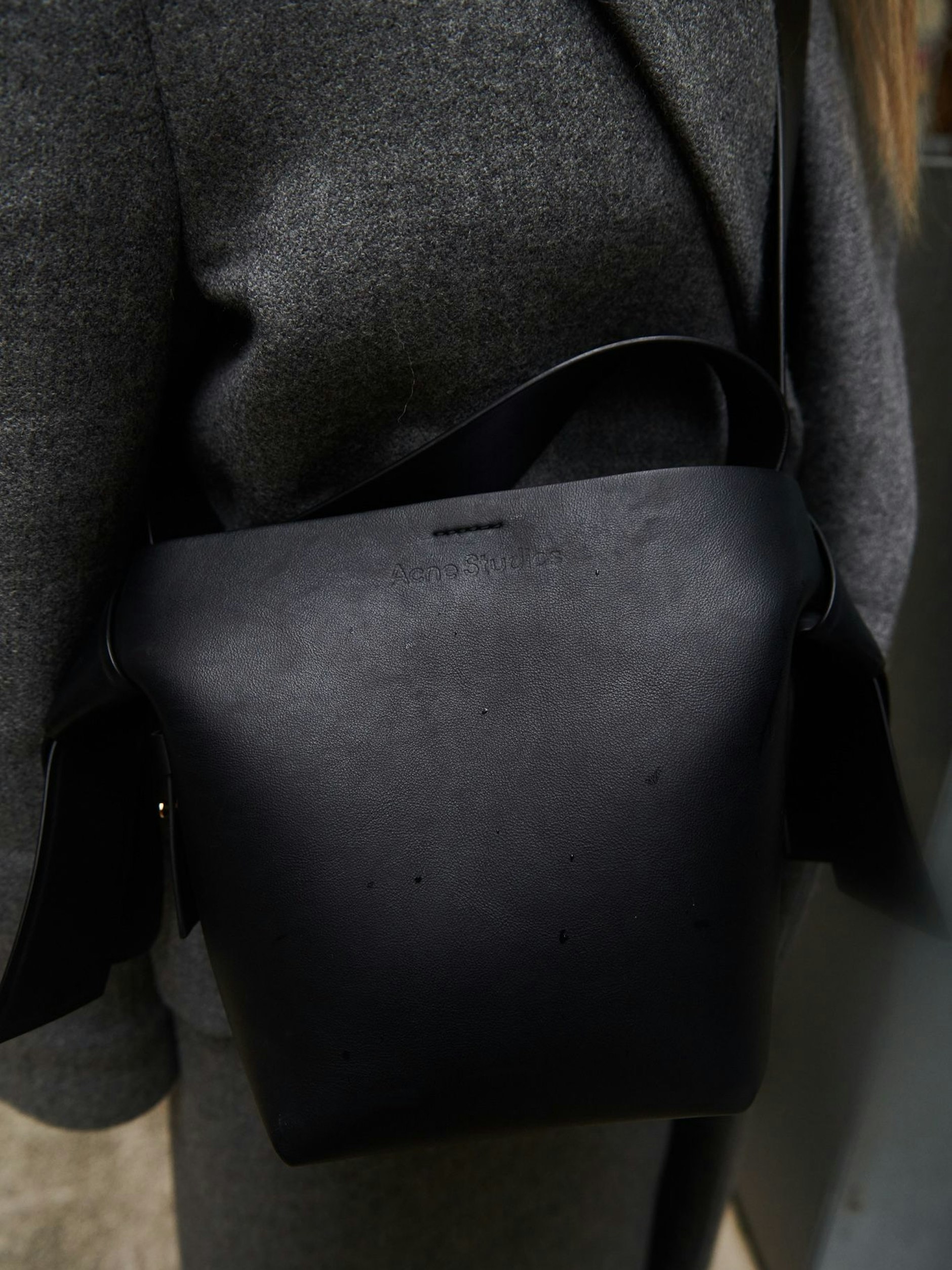Auch die schwarze Ledertasche ist von Acne Studios.