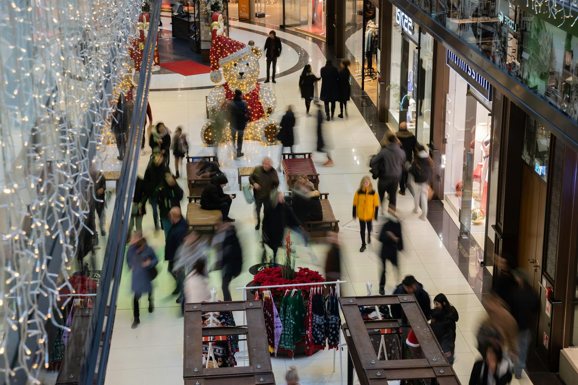 Menschen gehen am verkaufsoffenen Sonntag durch ein Einkaufszentrum am Potsdamer Platz. Auch 2023 dürfen Geschäfte an vier Sonntagen öffnen.