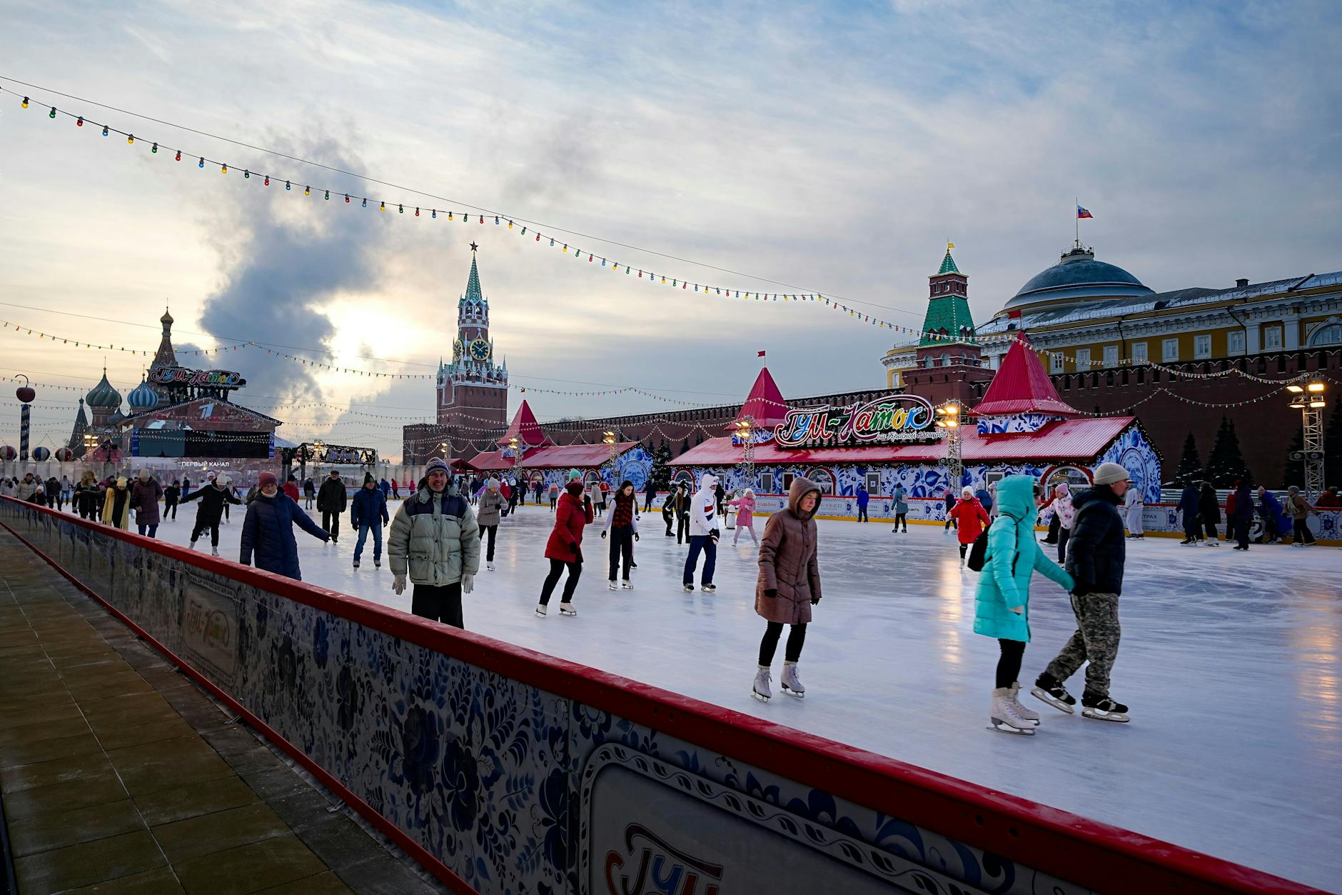 Alltag in Moskau. Menschen laufen Schlittschuh auf der Eisbahn auf dem Roten Platz, der für die Weihnachts- und Neujahrsfeierlichkeiten geschmückt ist.