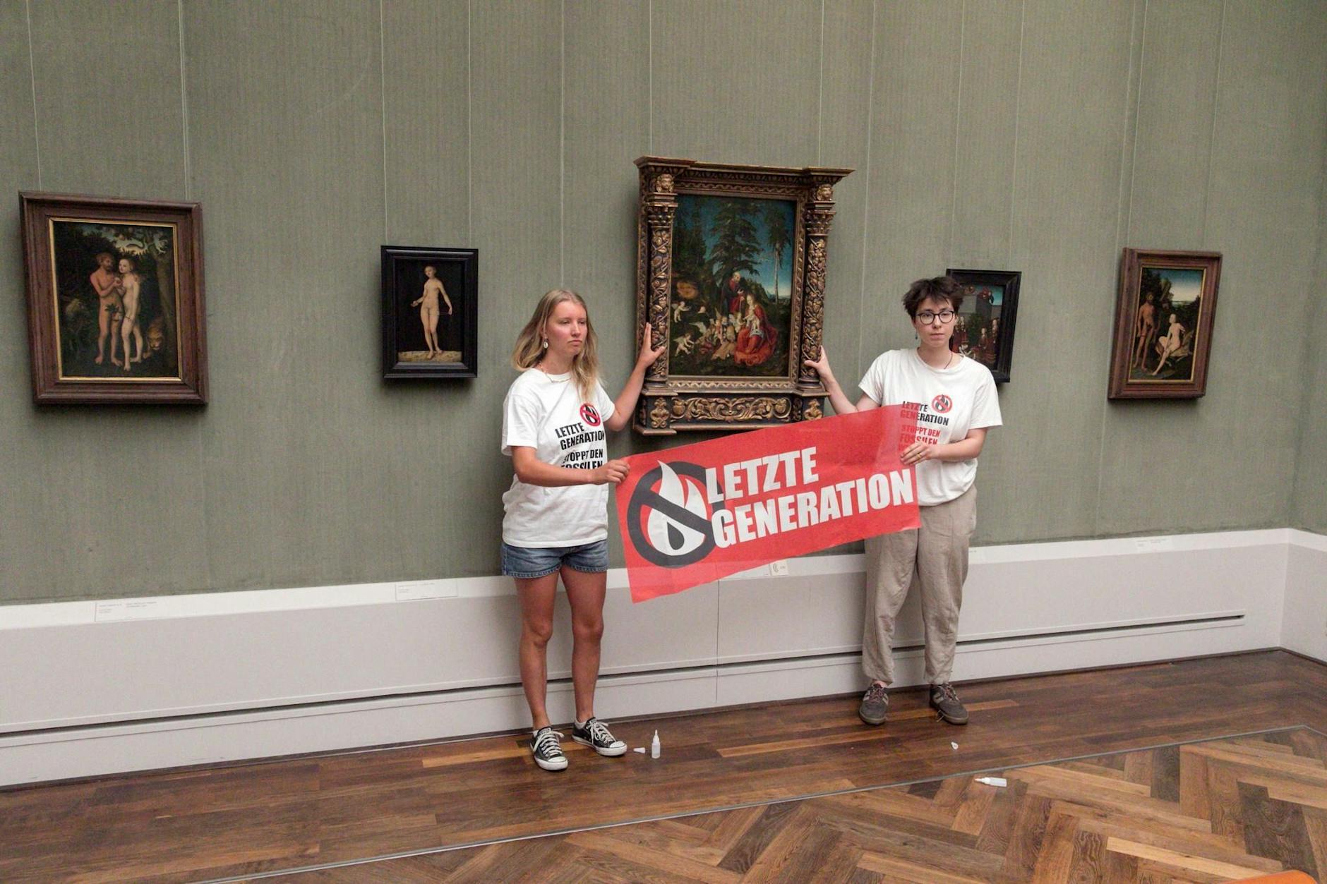 Aktivisten der Gruppe Letzte Generation kleben sich an einem Gemälde von Lucas Cranach fest.