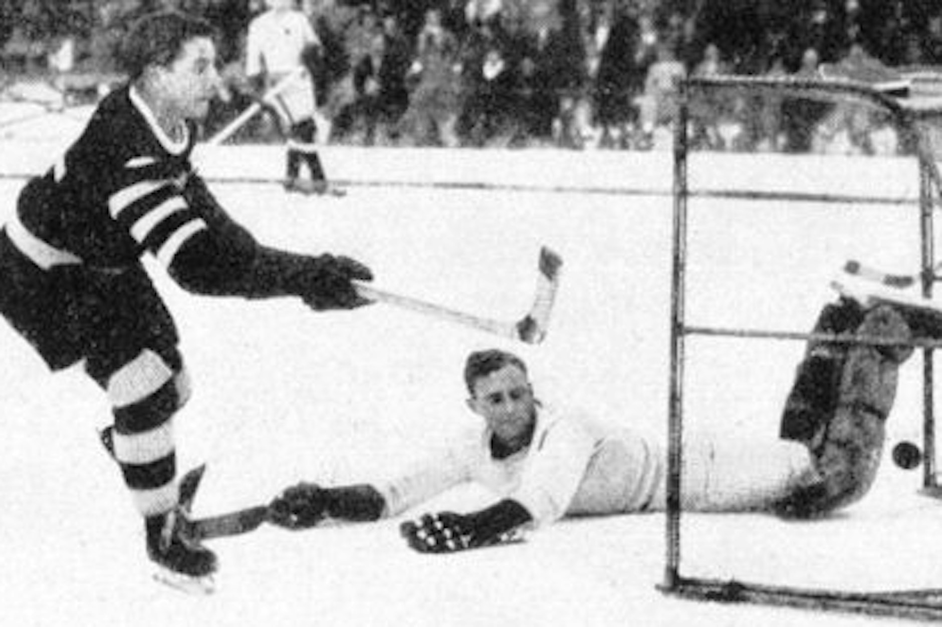 Ohne Helm mit freiem Blick: Schlittschuh-Club-Torjäger Rudi Ball trifft gegen einen damals kaum geschützten Torwart.