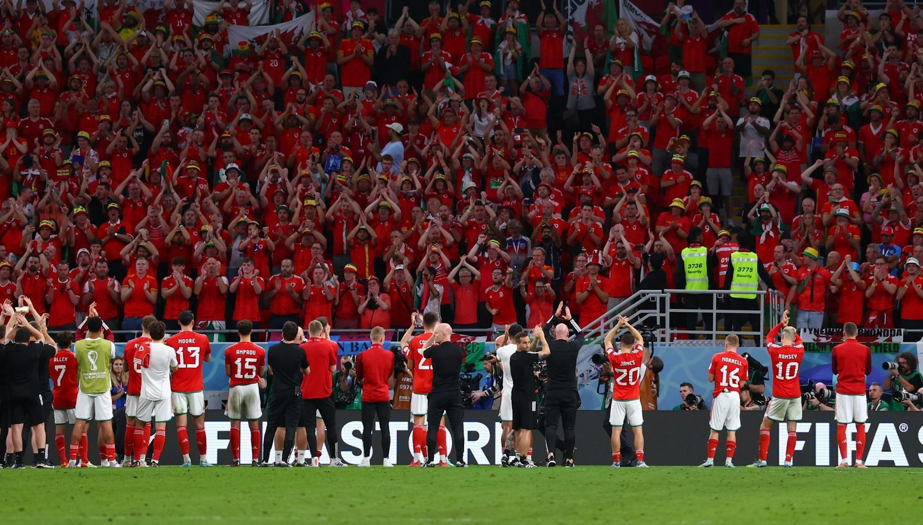 Während England das Achtelfinale feiert, verabschieden sich die Spieler von Wales nach dem Spiel von den Fans.