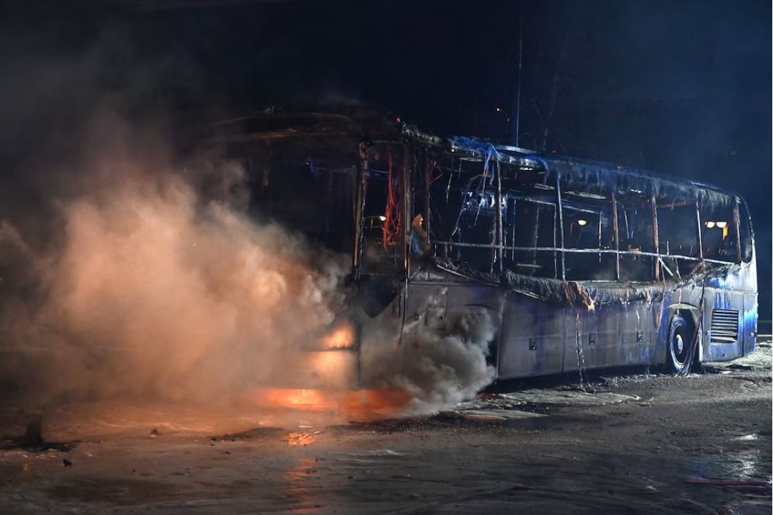 Firefighters extinguish a coach on Sonnenallee that had been set on fire by unknown persons.