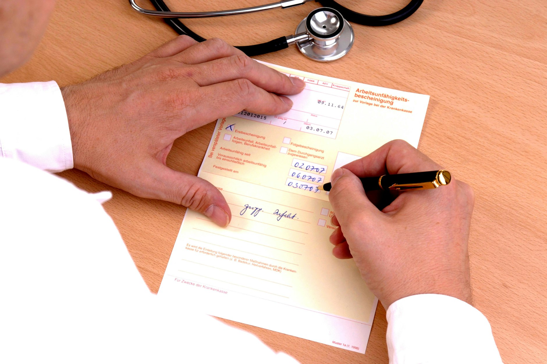 Ein Arzt schreibt eine Krankschreibung. (Symbolbild)