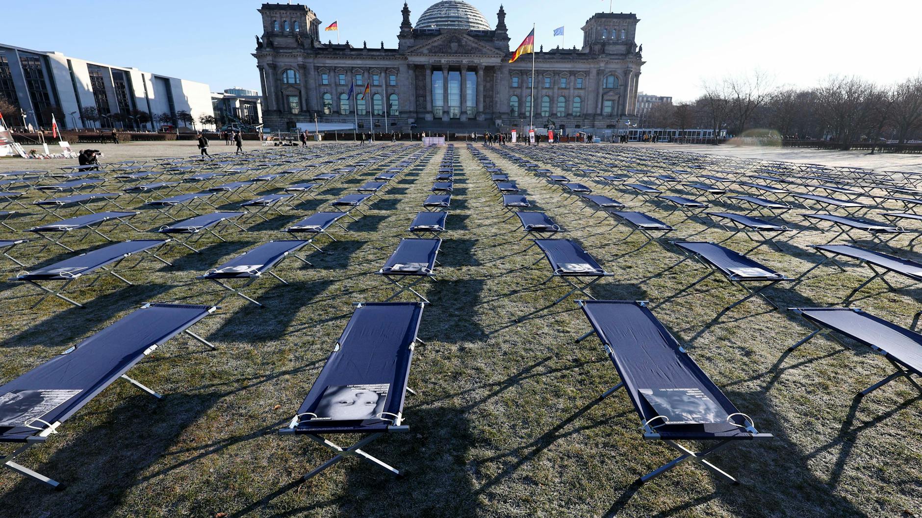 Feldbetten mit Porträts von Betroffenen aus ganz Deutschland sind vor dem Reichstag aufgestellt worden. 