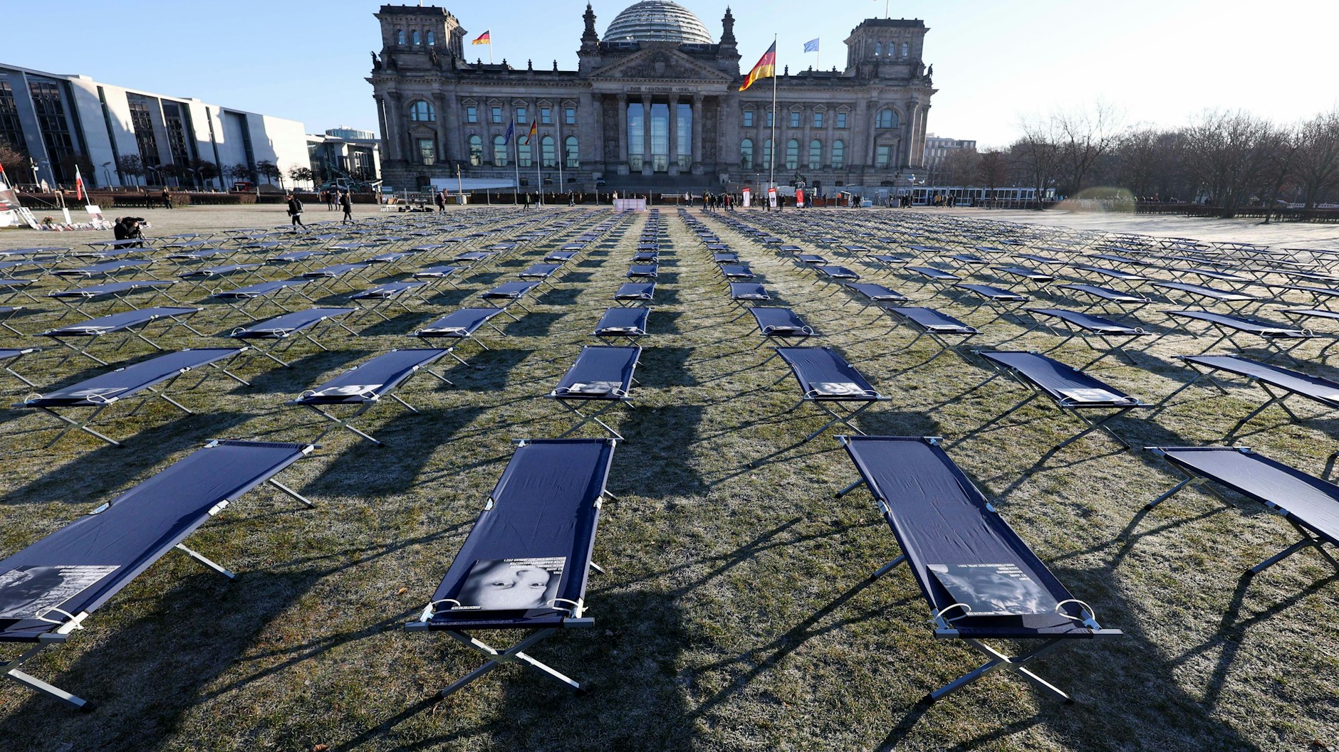 Feldbetten mit Porträts von Betroffenen aus ganz Deutschland sind vor dem Reichstag aufgestellt worden.&nbsp;