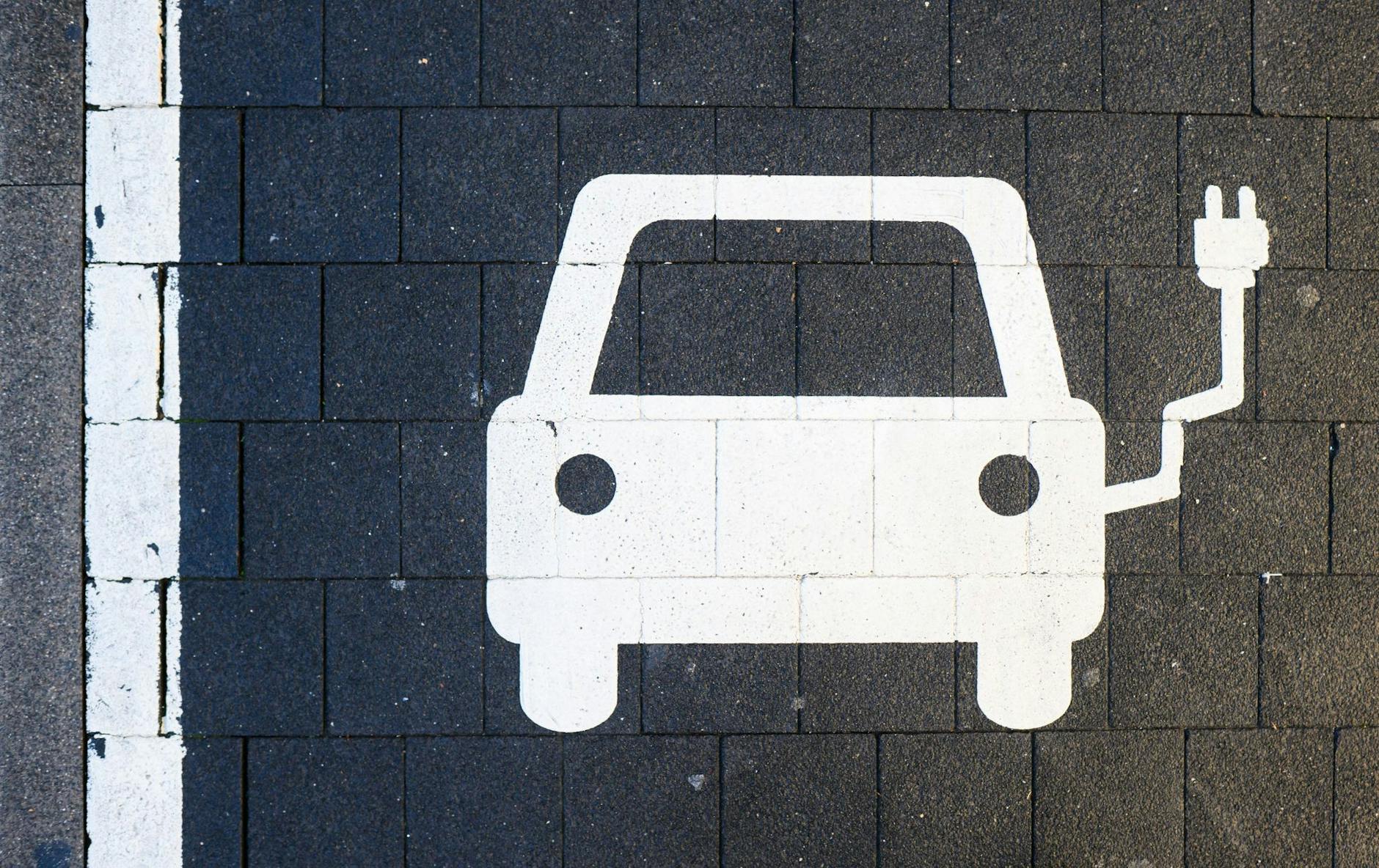 Ein Symbol markiert einen Parkplatz an einer Ladesäule für Elektroautos. bild