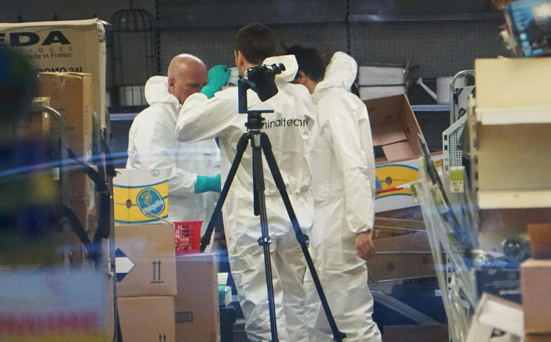 Mitarbeiter der Kriminaltechnik der Polizei sichern Spuren in einem Geschäft in Markdorf in der Nähe des Bodensees, wo am Samstag eine Frau getötet wurde.