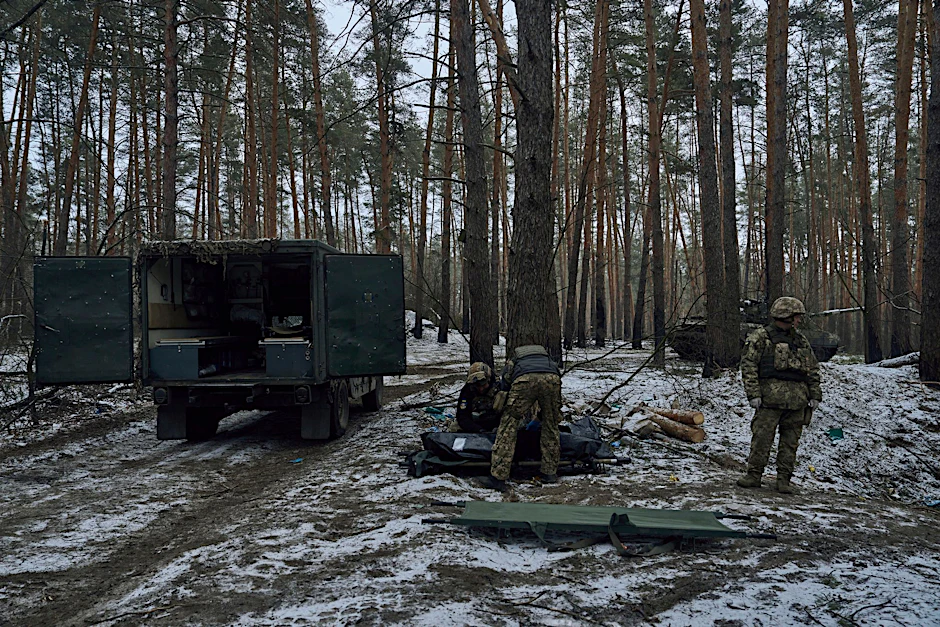 Militärsanitäter legen die Leiche eines in einem Gefecht in Kremenna getöteten Soldaten in einen Leichensack.