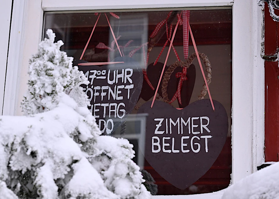 PRODUKTION - "Zimmer Belegt" steht auf dem Schild in der Tür eines Hauses in Oberhof.  