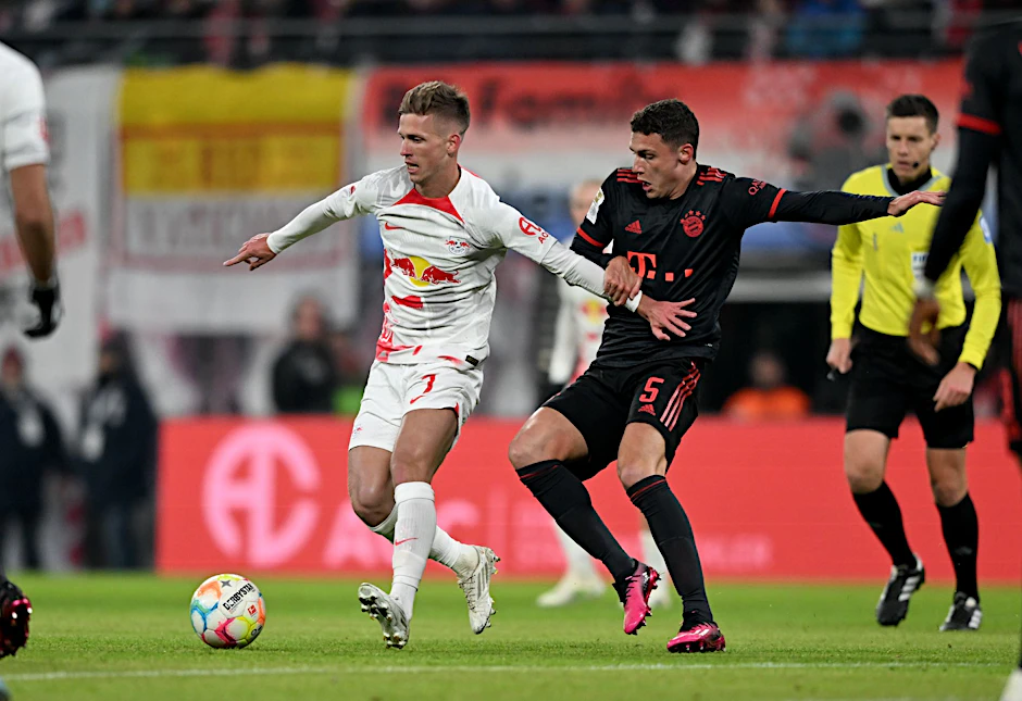 ARCHIV - Leipzigs Dani Olmo (l) und Münchens Benjamin Parvard kämpfen um den Ball.  